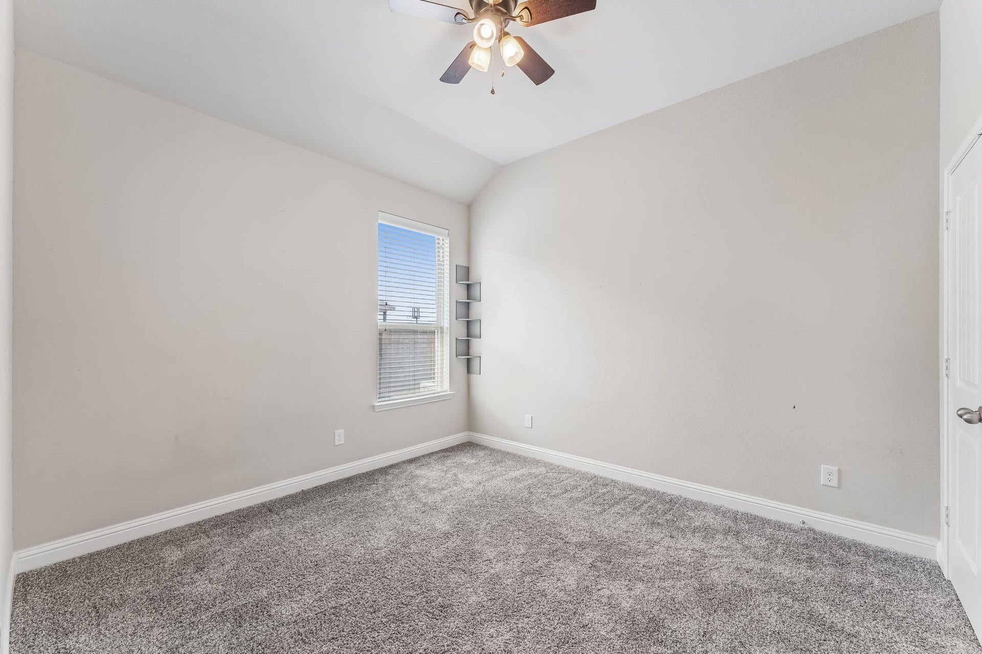 5107 Baroness Lane, Katy, TX 77493 A cozy bedroom with soft carpeting, neutral walls, a ceiling fan, and ample natural light from the window, perfect for relaxation.