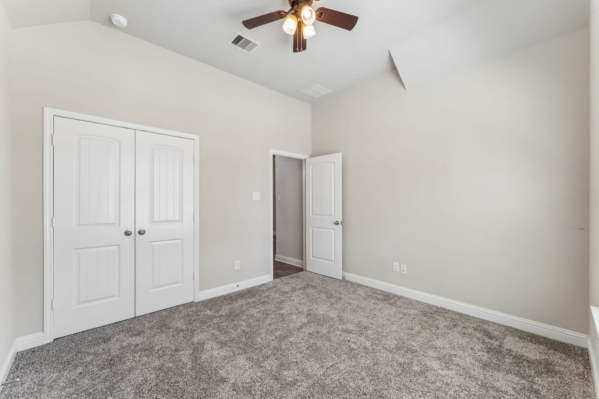 5107 Baroness Lane, Katy, TX 77493 Bright and spacious bedroom with plush carpeting, a ceiling fan, and ample closet space for comfortable living.