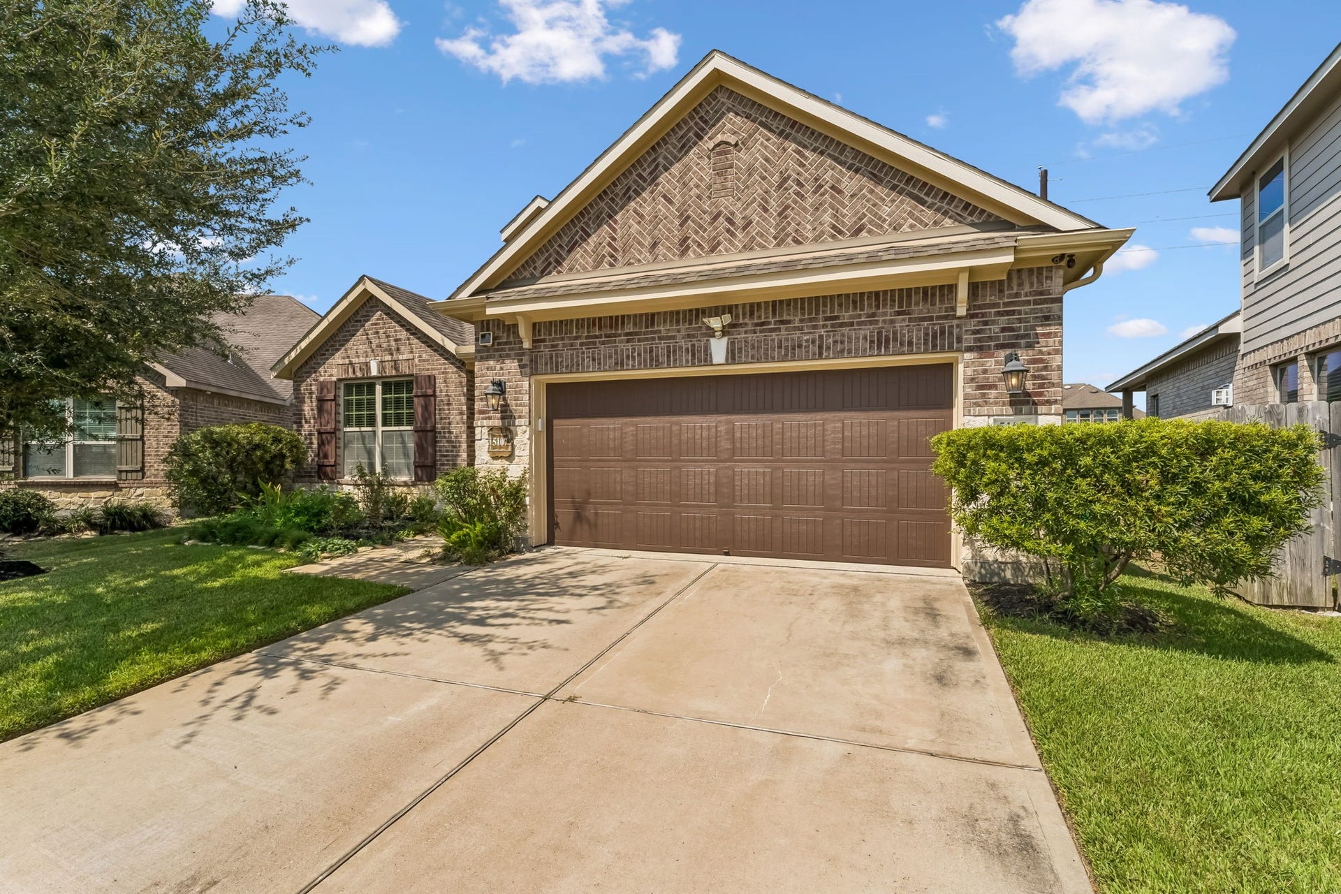 5107 Baroness Lane, Katy, TX 77493 Charming brick home with a well-maintained front yard, featuring a spacious two-car garage and inviting curb appeal.