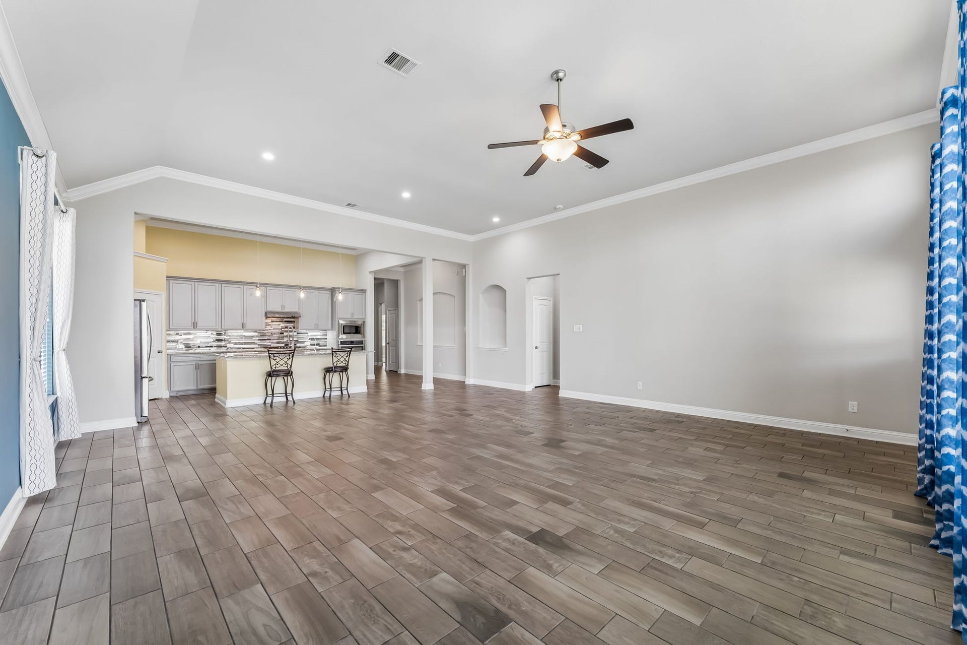 5107 Baroness Lane, Katy, TX 77493 Spacious open-concept living area with high ceilings, modern kitchen, and ample natural light.