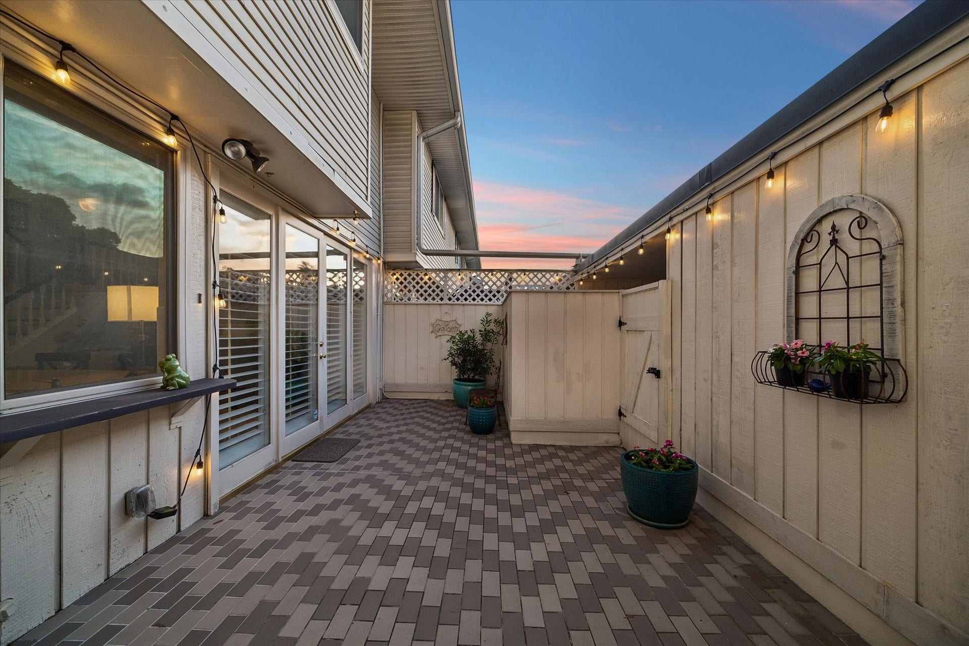 5904 Valley Forge Drive, #157, Houston, TX 77057 How will you use this spacious private back patio? Seller added the handsome tile and string lights so now you can create your own outdoor oasis! NOTE: outdoor electrical plugs, hidden hose bib, painted privacy fence w/ gate to garage area and concealed A/C unit, and French doors from the grand Family Room/Kitchen Area!