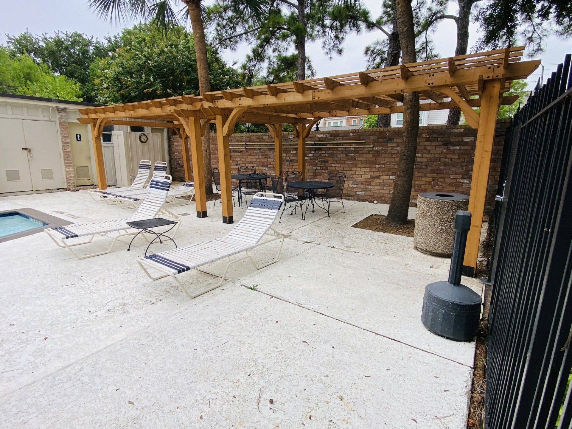 5904 Valley Forge Drive, #157, Houston, TX 77057 Close up of the new Pergola providing shade to some of the chaise lounge chairs and wrought iron outdoor dining tables and chairs! Note the wonderful "Cool-Crete" decking of the pool! BRING YOUR TOWEL & ENJOY!