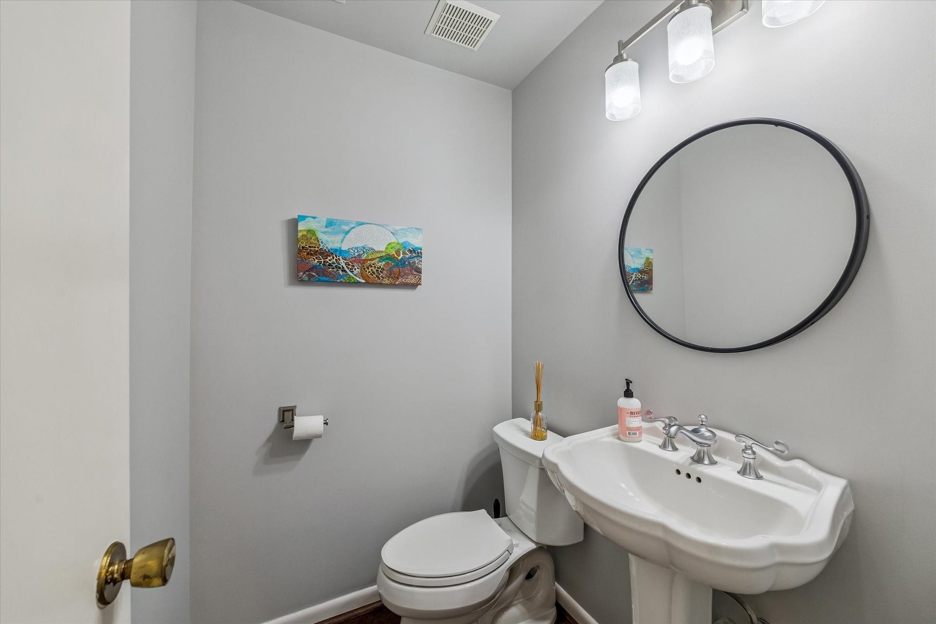 5904 Valley Forge Drive, #157, Houston, TX 77057 Cleverly located downstairs off the hall of Living/Dining Room, the remodeled Powder Room features a white porcelain scalloped pedestal sink, decorative framed mirror, new light fixture, stylish wood floors and more!