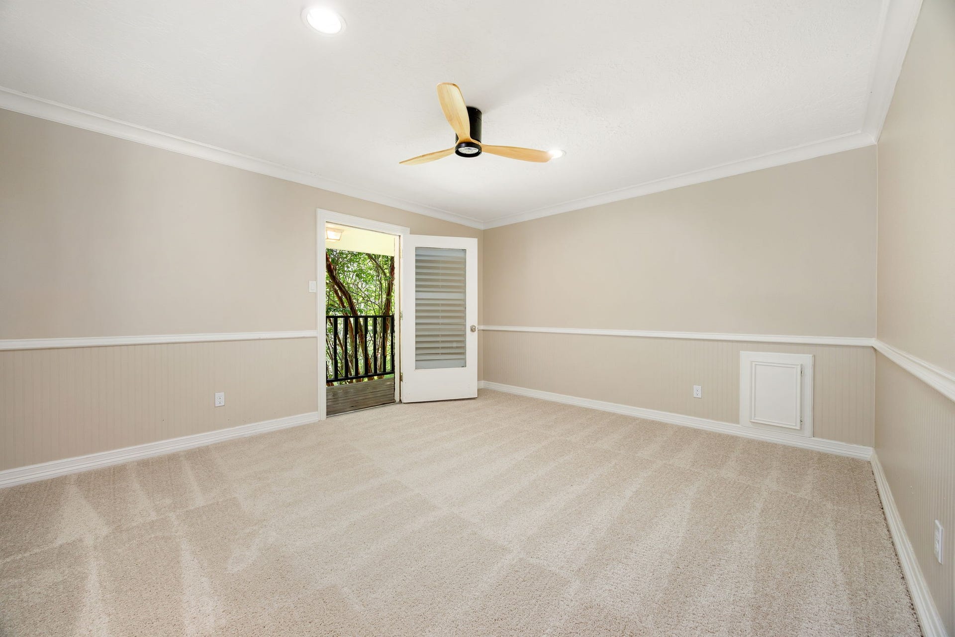 Third secondary bedroom upstairs with balcony access, fresh paint and new carpet.