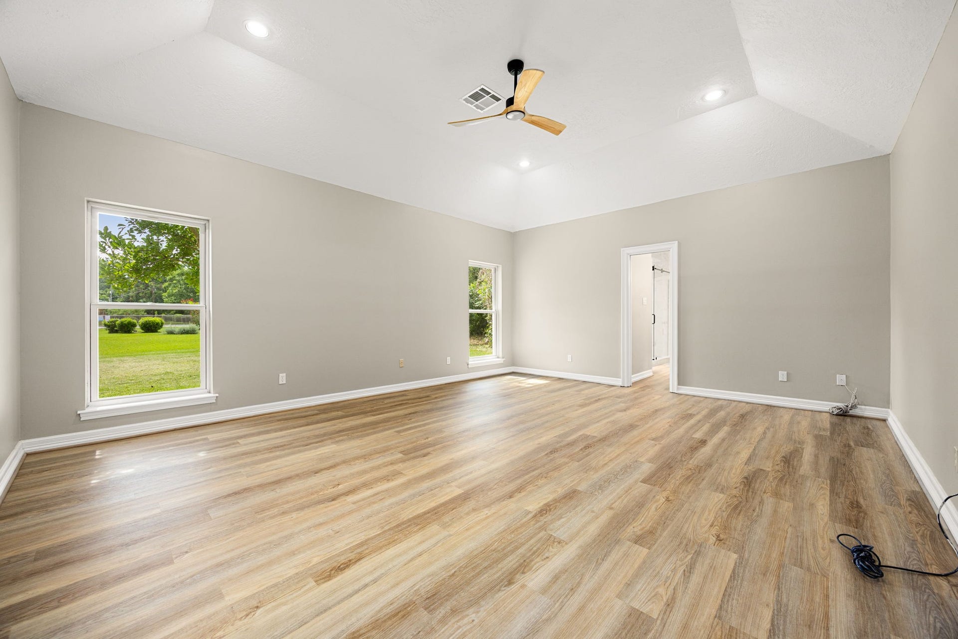 Oversized primary bedroom with ample room for a sitting area. You will be impressed with the size of this room.