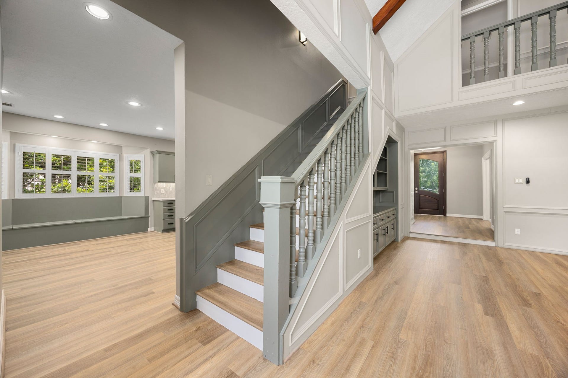 Open staircase overlooking the dramatic two-story living area leading to the three secondary bedrooms and jack-n-jill bathrooms.