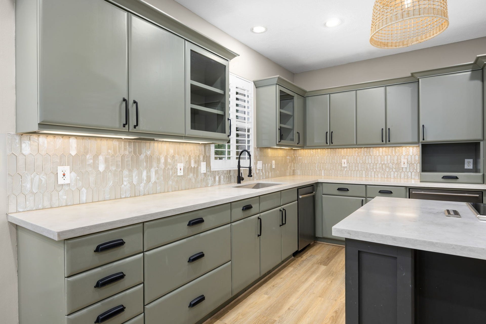Granite countertops, abundant cabinetry, and designer lighting throughout.