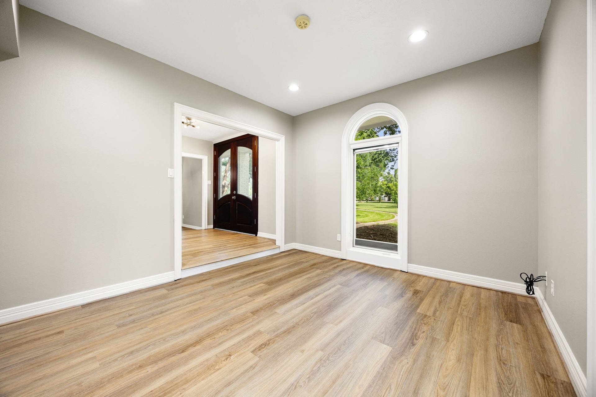 Dedicated home office or flex room at the front of the home offering abundant natural light, custom windows and blinds to control light and add privacy.