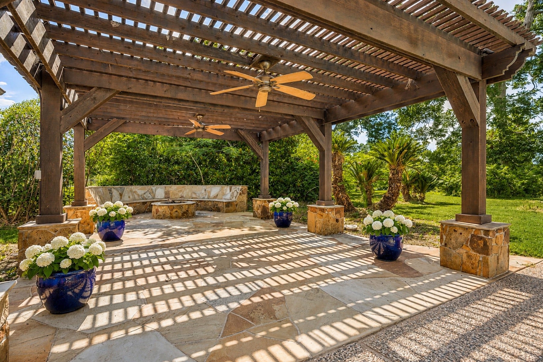 Pergola-covered outdoor living area with firepit perfect for year-round use. Add your large gathering table for ease in entertaining.