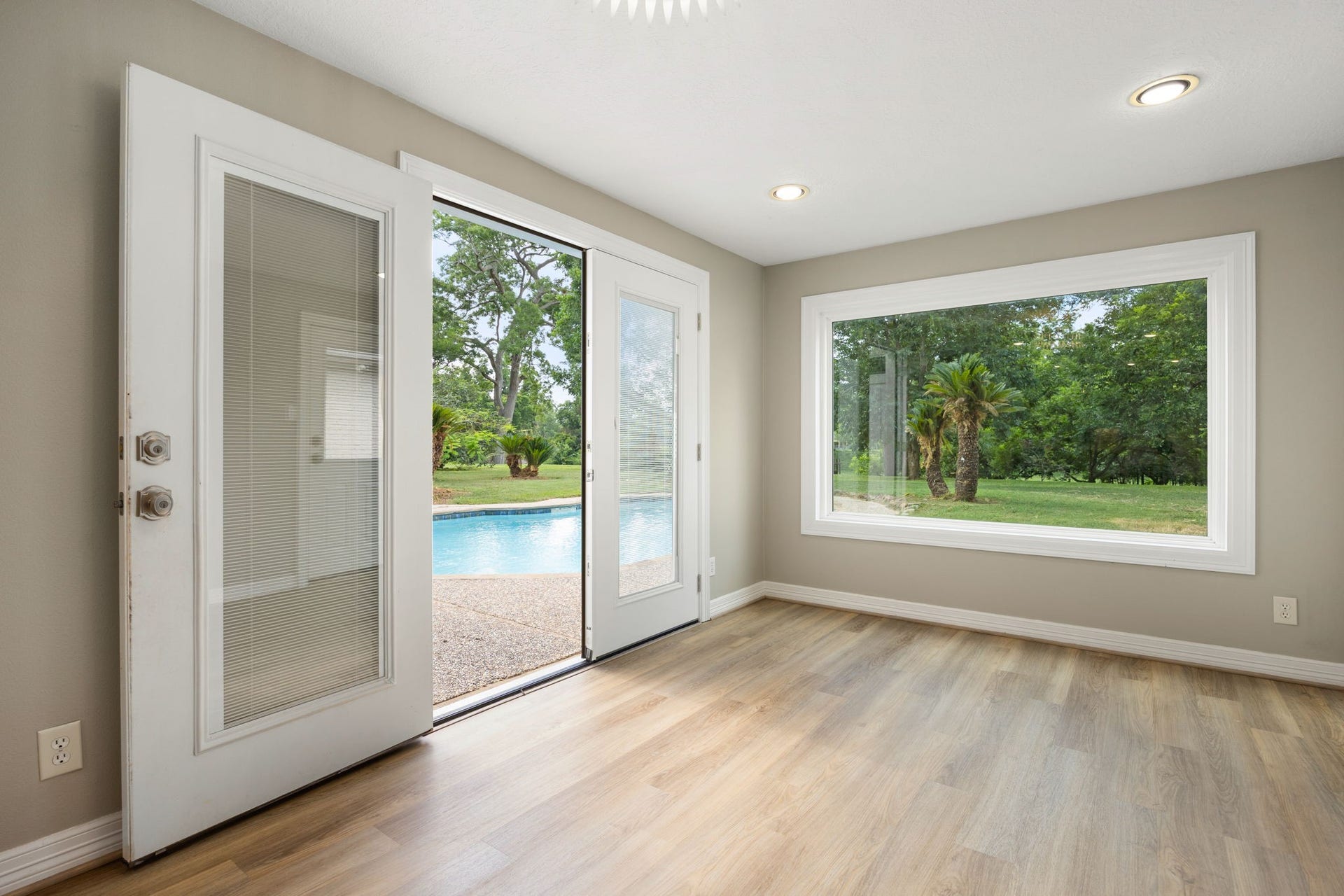 Flex space off the kitchen with peaceful views of the backyard oasis. This space is perfect for a second living space, exercise area, 2nd office or whatever your needs are.