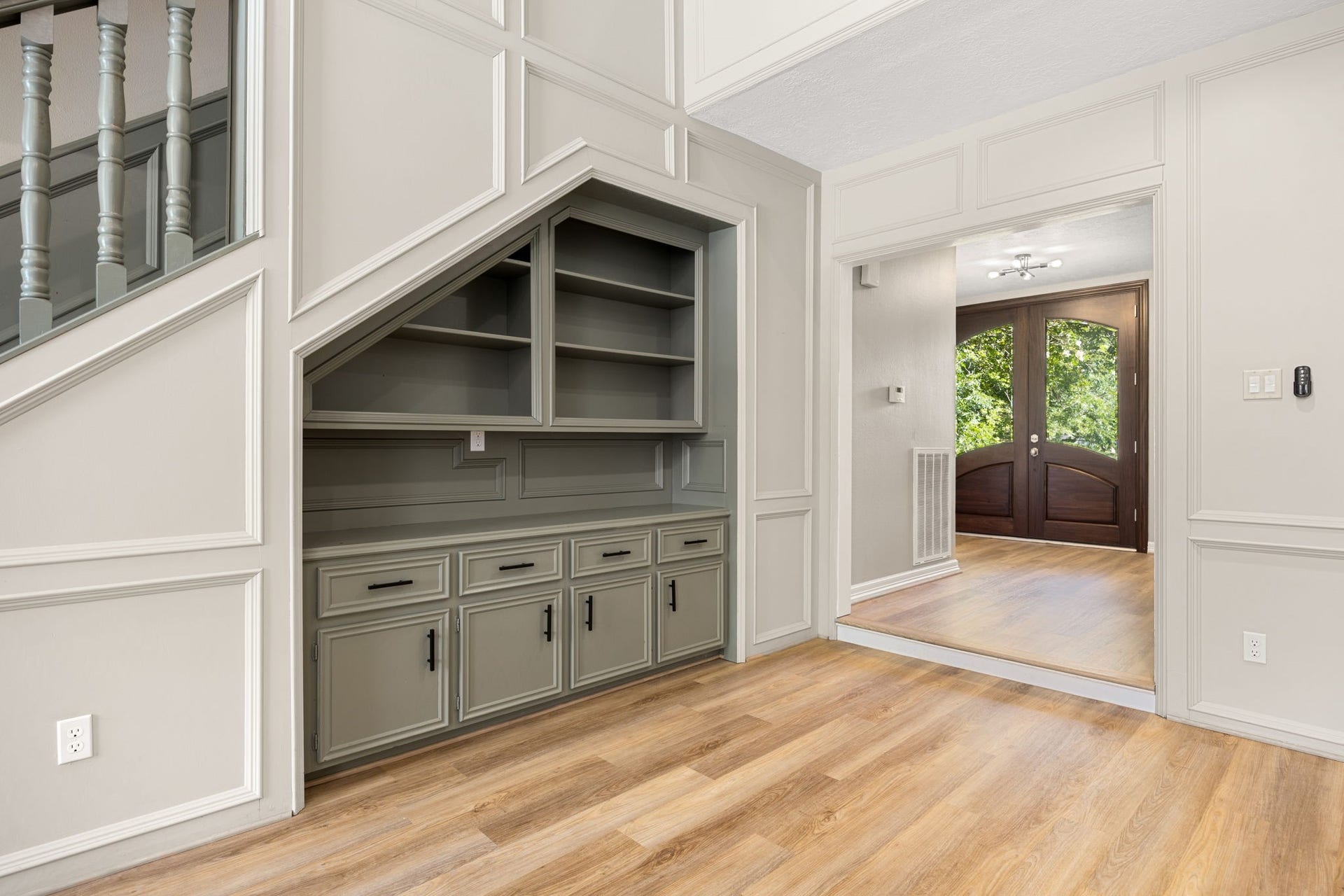 Beautiful custom built-ins enhance the living room with both style and functionality. Luxury, wood-look vinyl plank flooring throughout the downstairs and stairway.