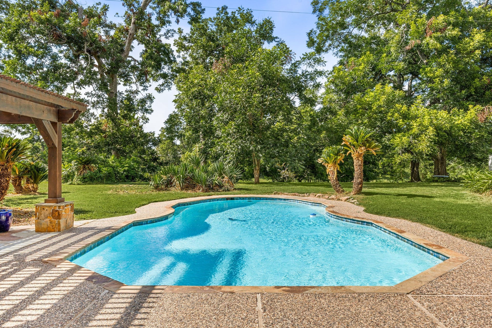 Sparkling Gunite pool surrounded by mature trees and exceptional privacy.