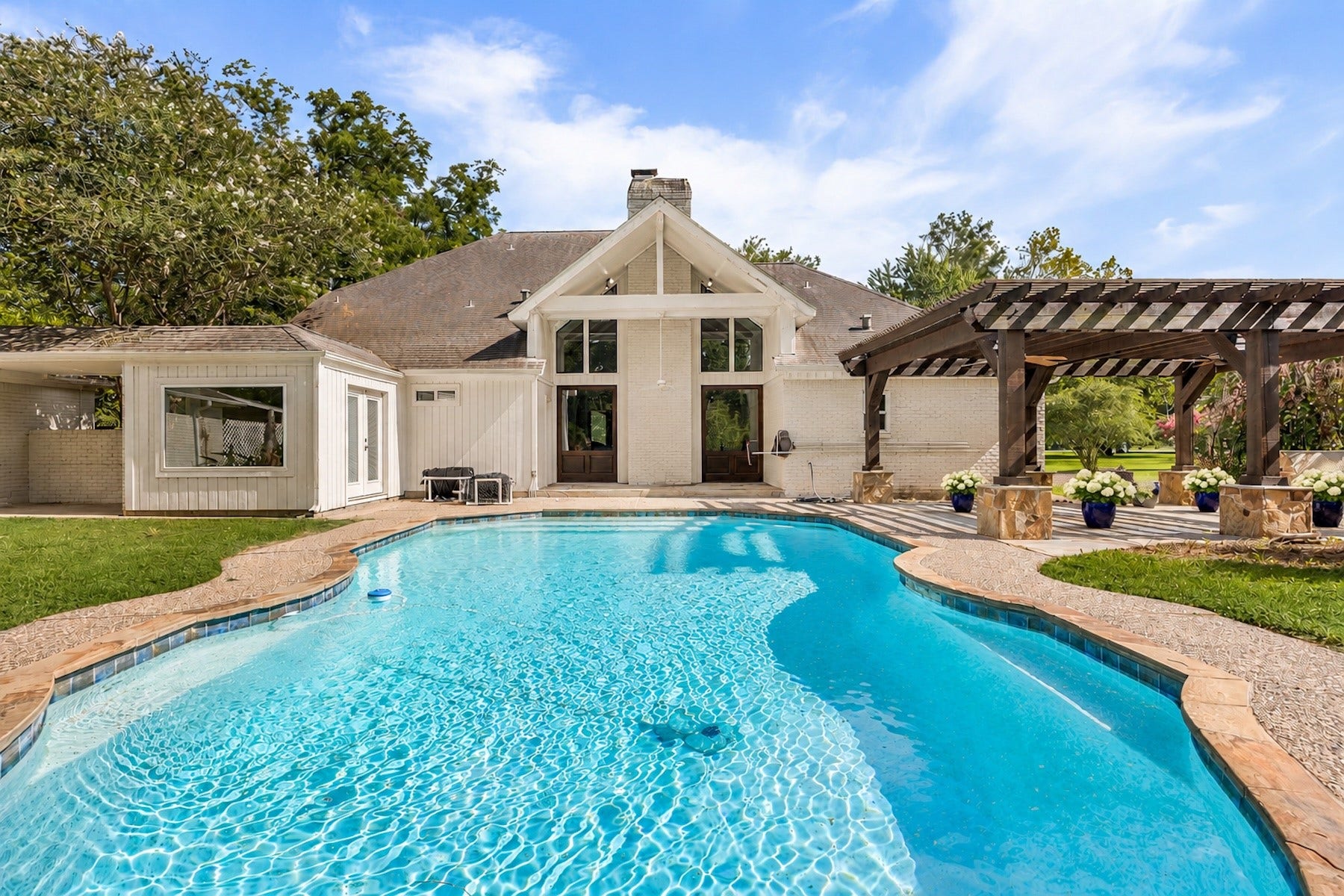 Resort-style pool overlooking the beautifully updated main residence and guest house.