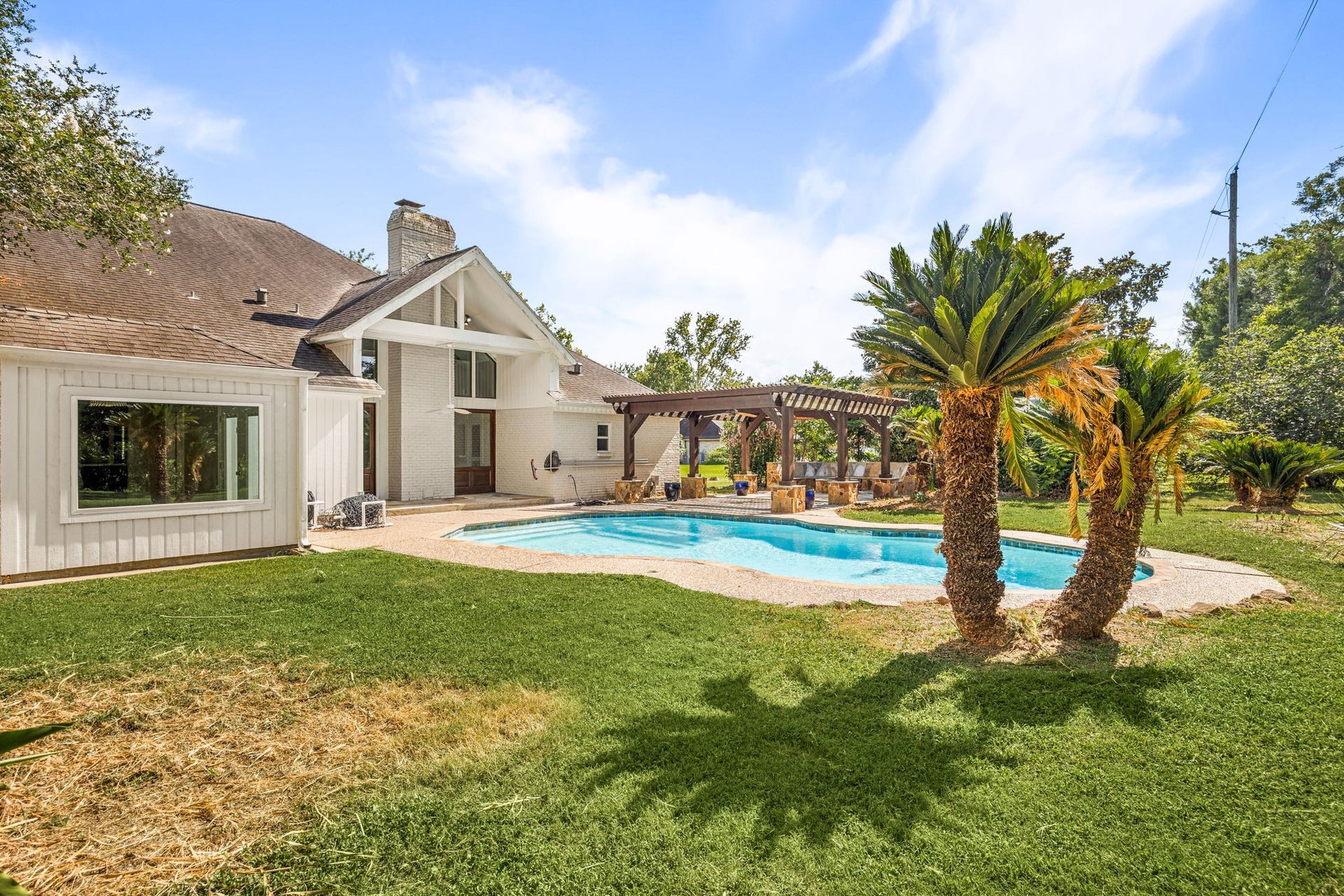 Backyard oasis featuring multiple outdoor entertaining spaces.