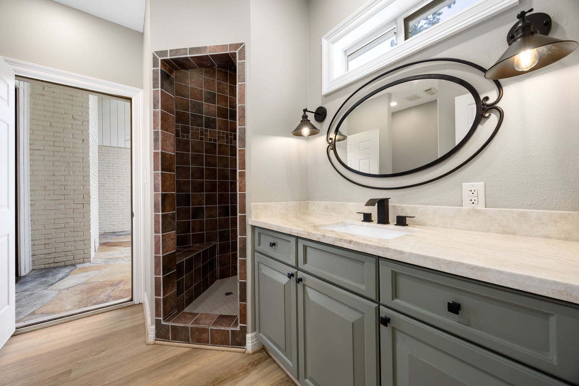 Convenient full bath with direct access from the garage and pool areaperfect for guests and outdoor entertaining.