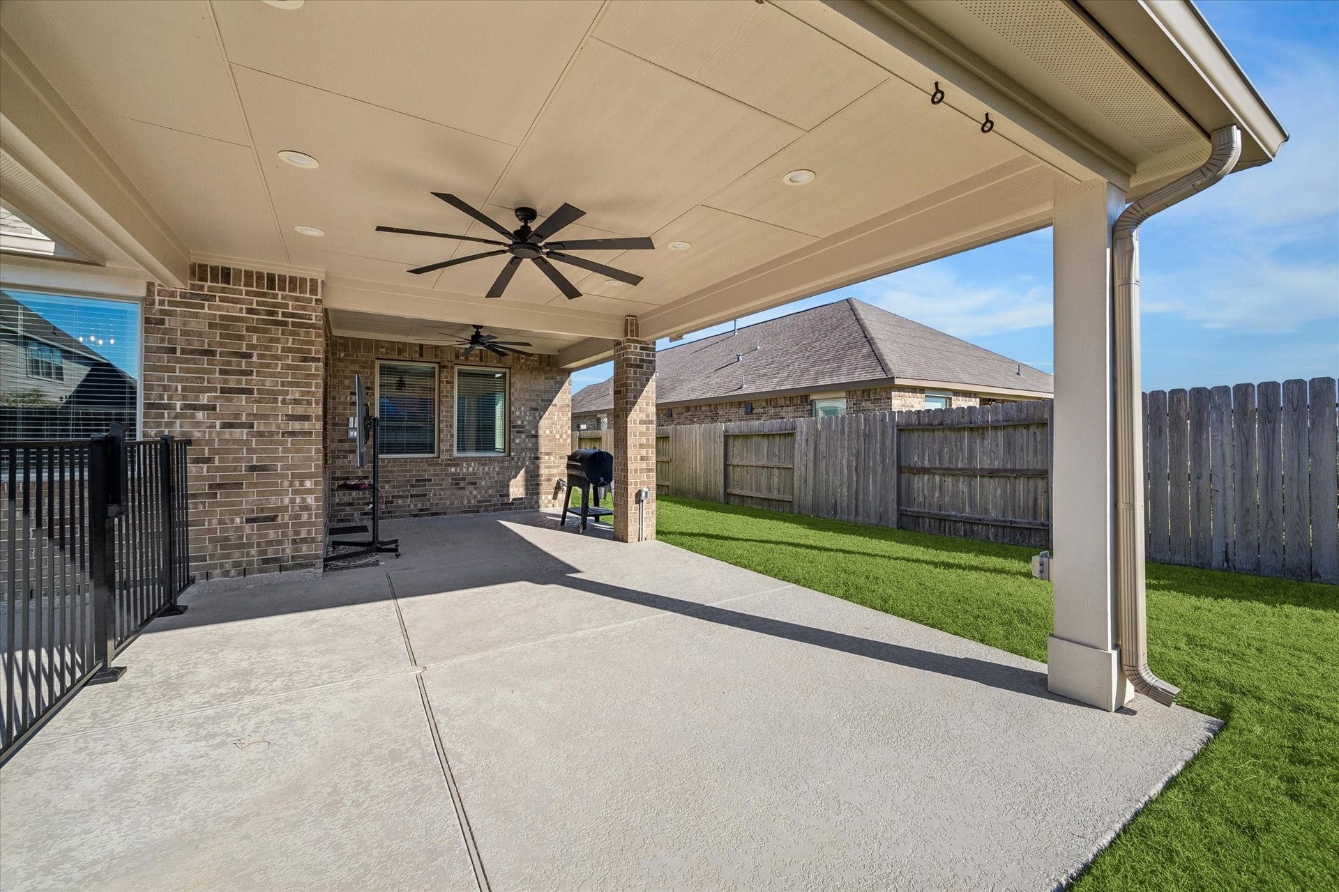 14918 Lake Shore Avenue, Mont Belvieu, TX 77523 Extended in 2025, the covered patio offers generous space for outdoor dining and lounging, with upgraded ceiling fans and a gas connection ready for a future outdoor kitchen.