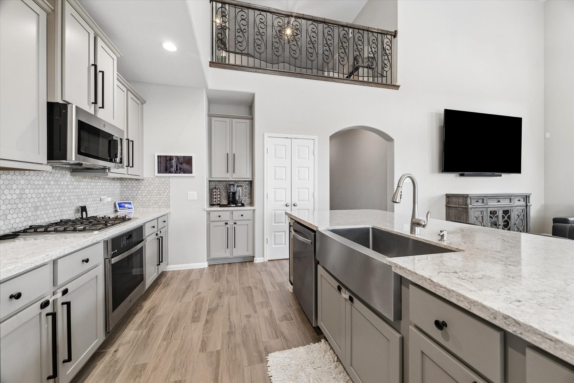 14918 Lake Shore Avenue, Mont Belvieu, TX 77523 Light cabinetry, stainless steel appliances, and a generous island anchor a kitchen that stays connected to the main living area.