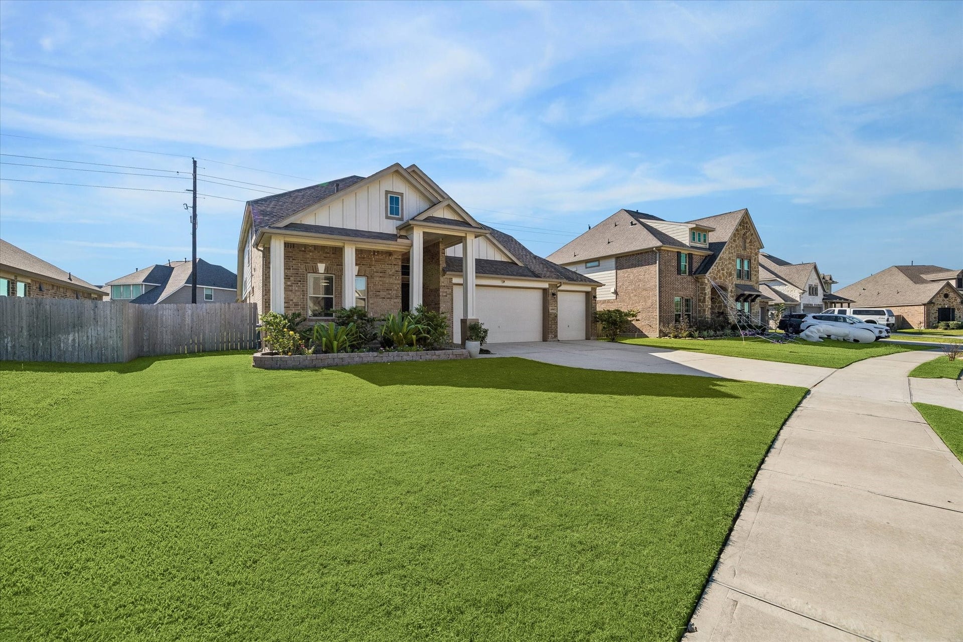 14918 Lake Shore Avenue, Mont Belvieu, TX 77523 Set on a 9,766-square-foot lot in Lakes of Champions Estates, the home offers an expansive front lawn, refreshed Bermuda grass, and a sidewalk-lined streetscape.