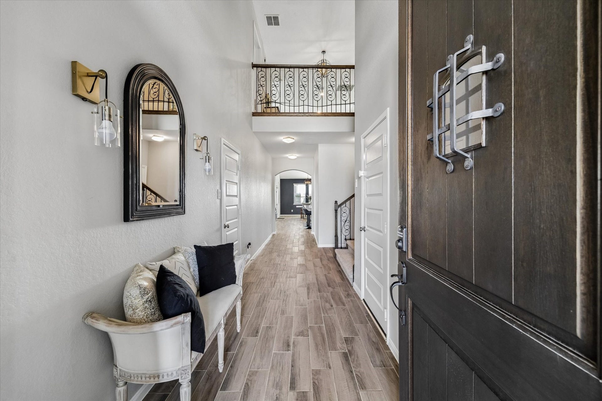 14918 Lake Shore Avenue, Mont Belvieu, TX 77523 A soaring foyer, wood-look flooring, and an upper-level overlook create a memorable welcome from the moment you step inside.