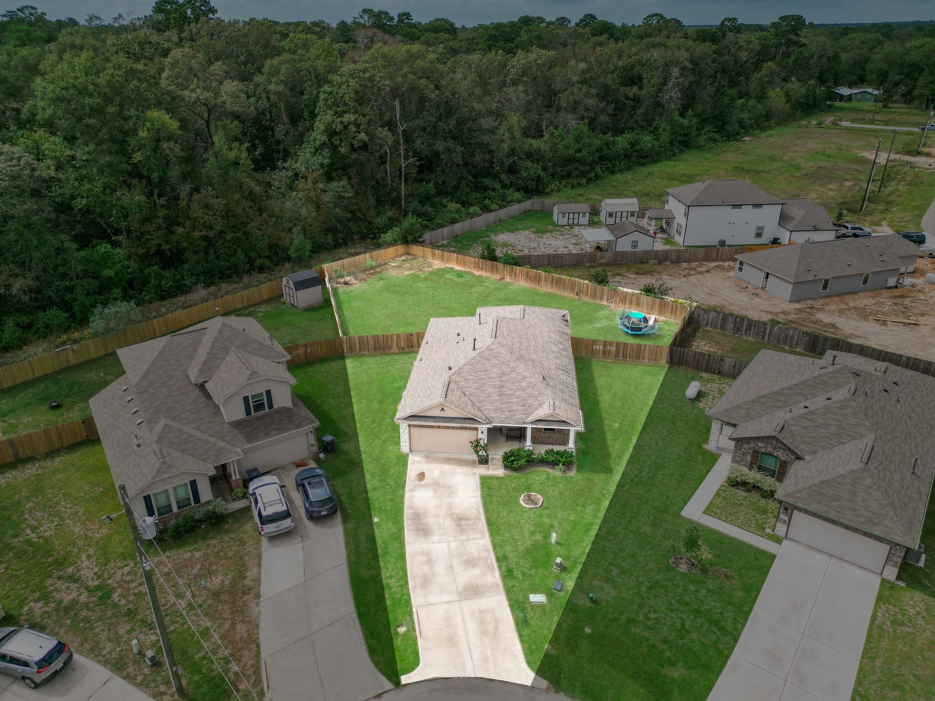 11064 Patriot Court, Cleveland, TX 77328 Charming single-story home nestled in a quiet cul-de-sac, featuring a spacious backyard perfect for outdoor activities, surrounded by lush greenery for added privacy.