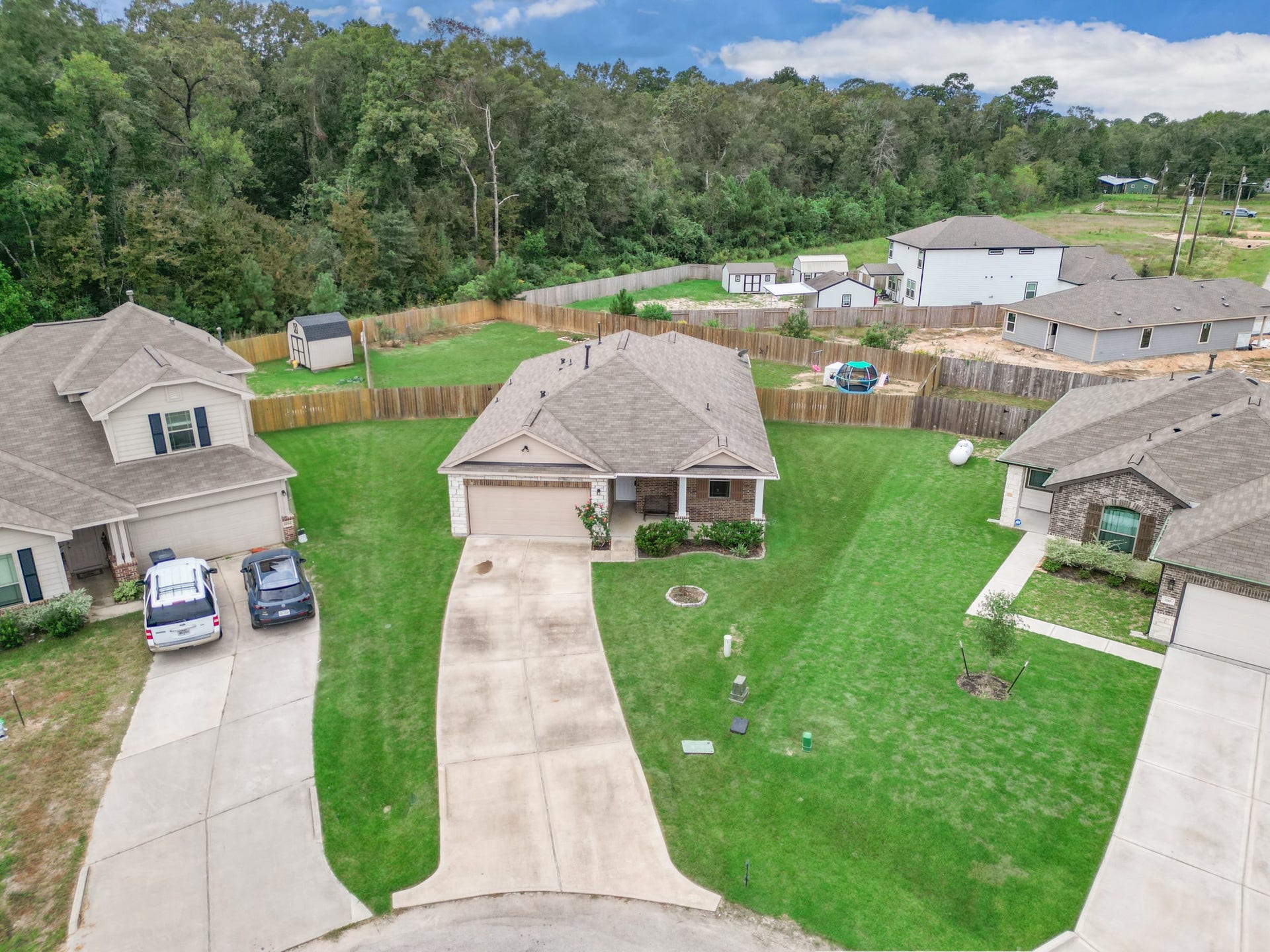 11064 Patriot Court, Cleveland, TX 77328 Charming single-story home on a spacious lot, featuring a well-maintained lawn and a cozy front porch. Located in a peaceful cul-de-sac with a fenced backyard, perfect for privacy and outdoor activities.
