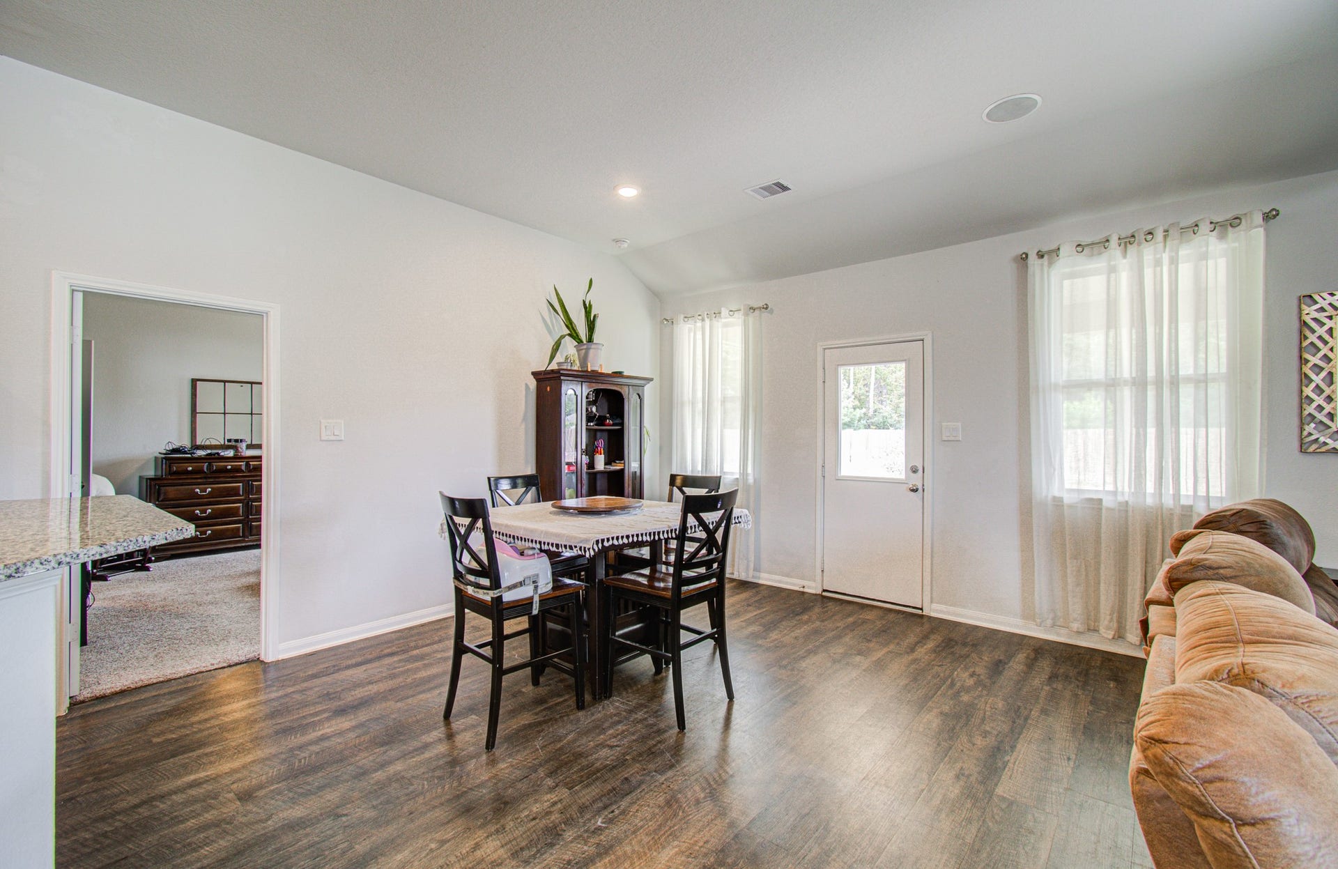 11064 Patriot Court, Cleveland, TX 77328 Bright and inviting living space , a cozy dining area, and ample natural light streaming through large windows.