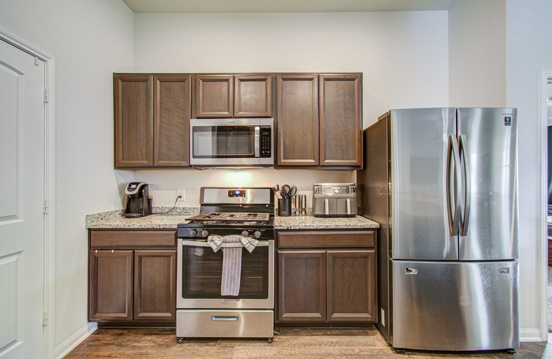 11064 Patriot Court, Cleveland, TX 77328 Modern kitchen featuring sleek stainless steel appliances, rich wood cabinetry, and elegant granite countertops.