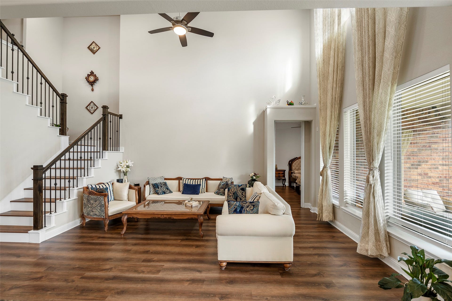 10810 Carolina Willow Court, Cypress, TX 77433 Spacious living room with soaring ceilings and tall windows bringing in abundant natural light.