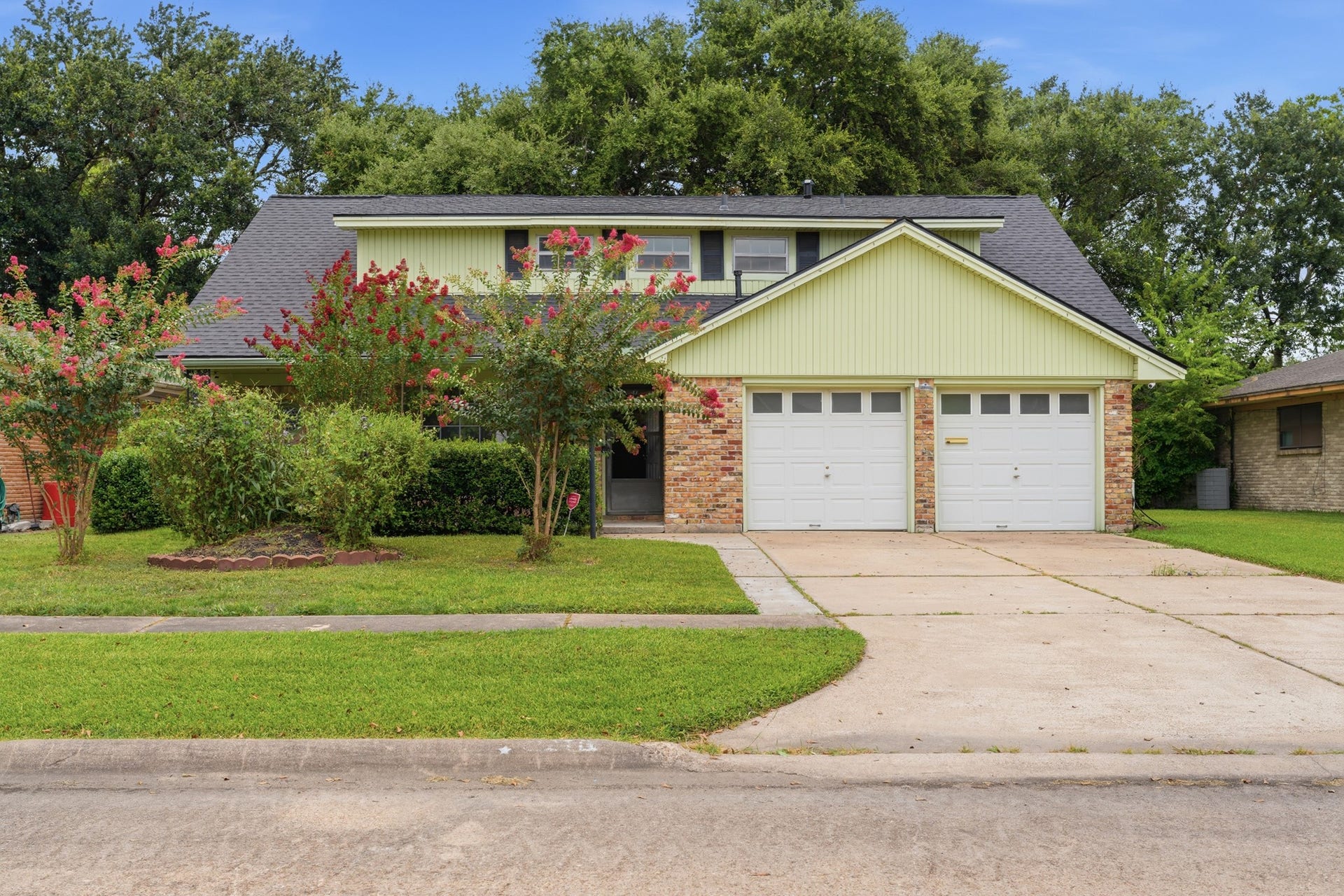 2216 Peach Lane, Pasadena, TX 77502 The property is set against a backdrop of lush greenery, creating a welcoming and serene atmosphere.