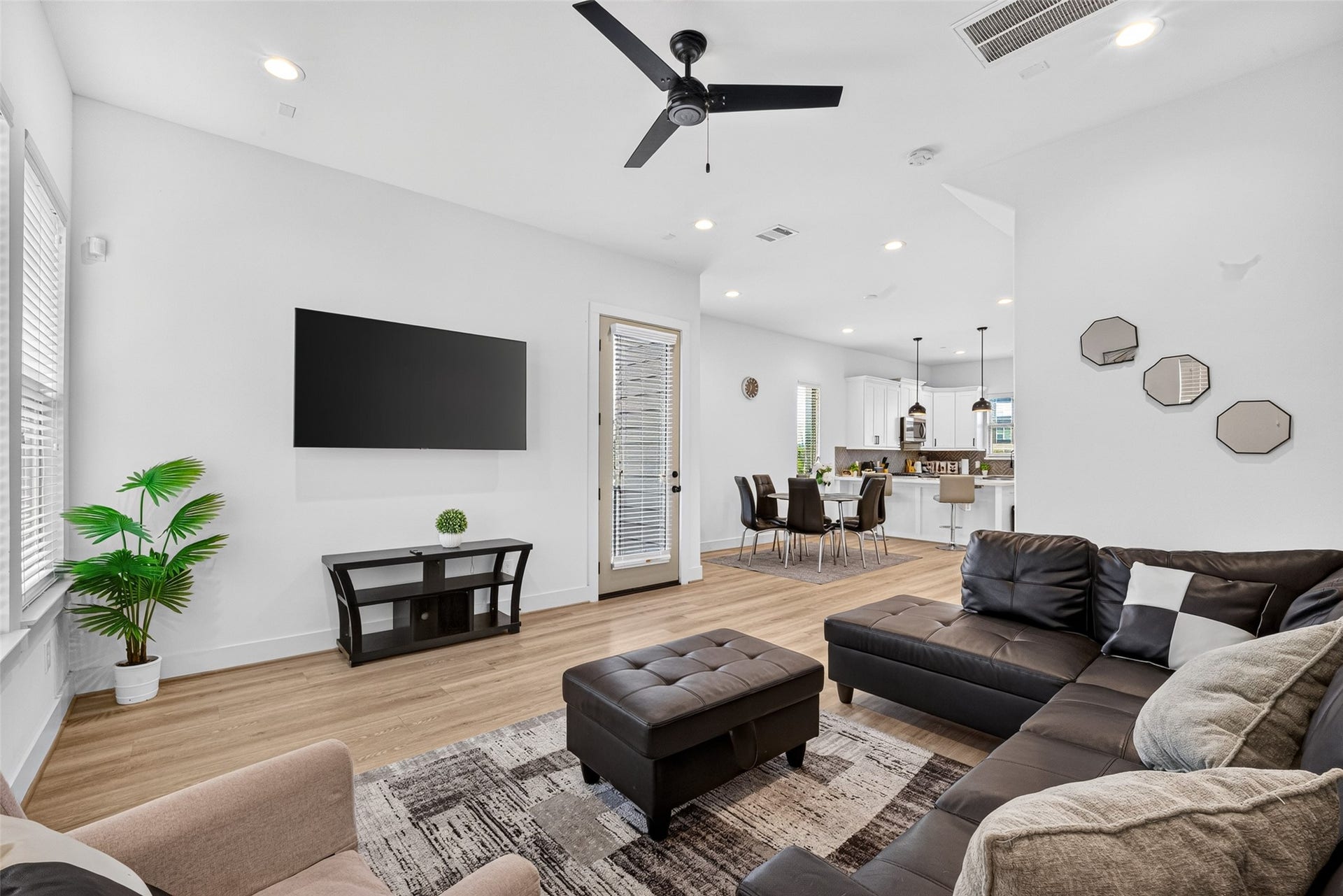 Polished hardwood floors seamlessly tie the main level together, uniting the central living area, dining, and kitchen.