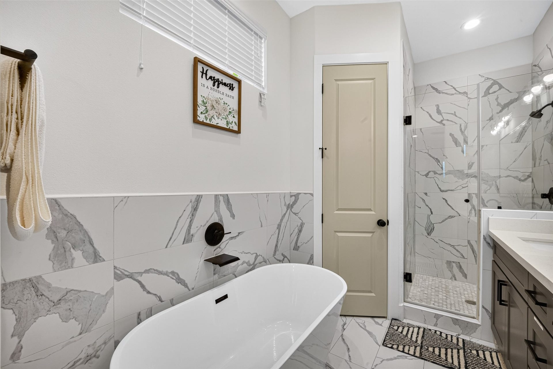 Dedicated to relaxation, a deep freestanding soaking tub serves as the centerpiece of the primary bath setup.