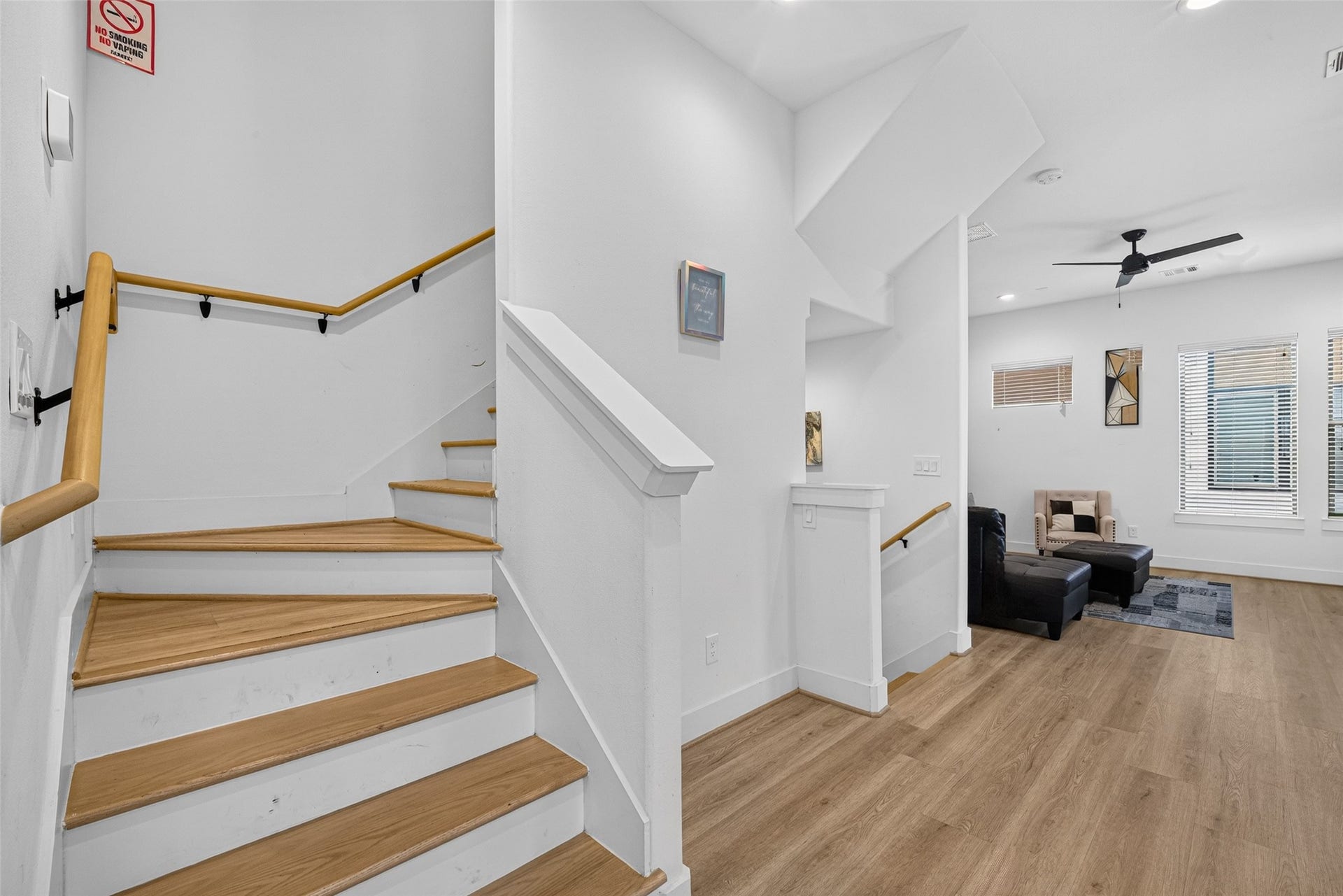 Architectural continuity carries upward as the wooden stairwell ascends toward the top-floor.