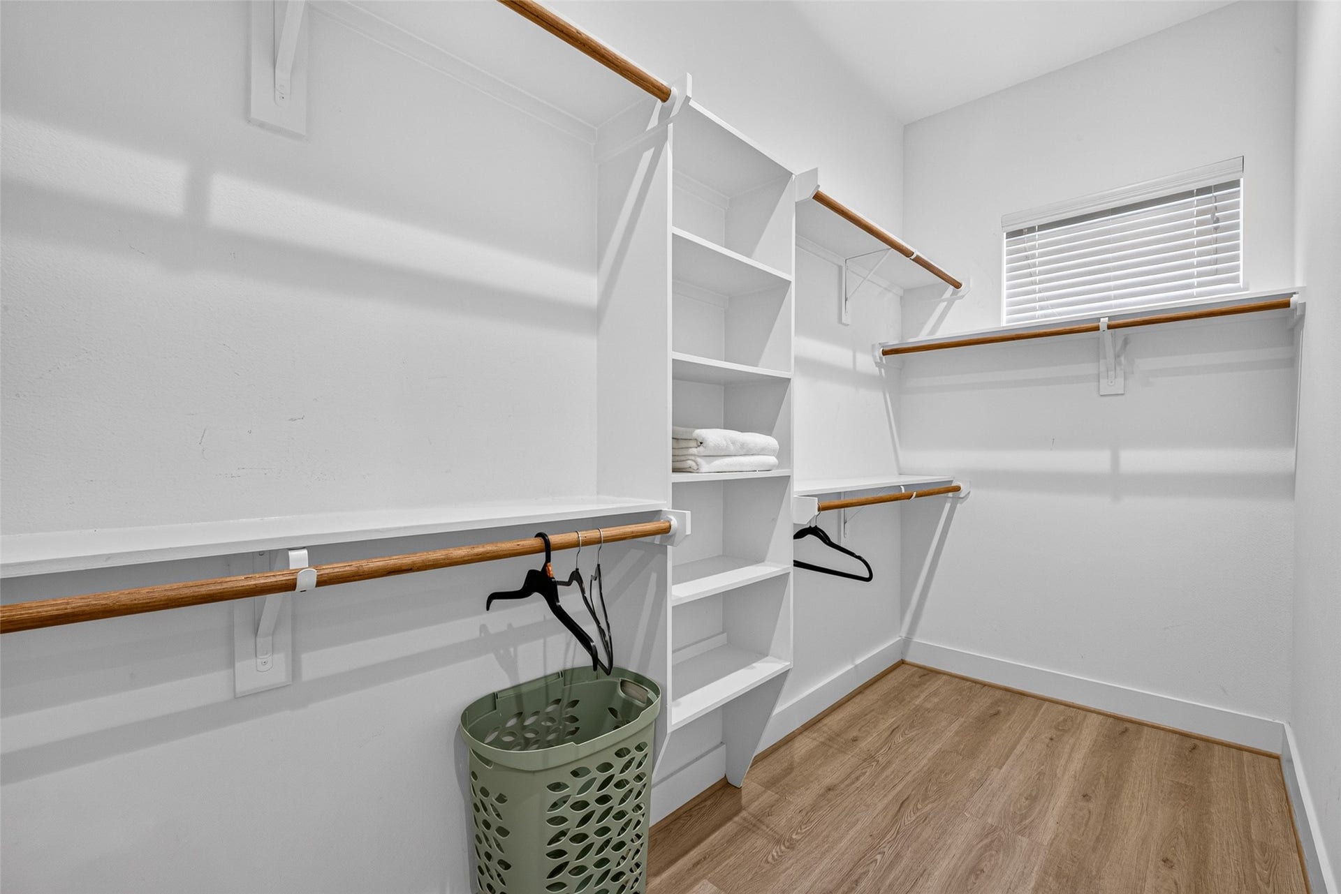 Maximized organization awaits inside this large full-entry closet, fully outfitted with custom hanging rods and multi-tier shelving.