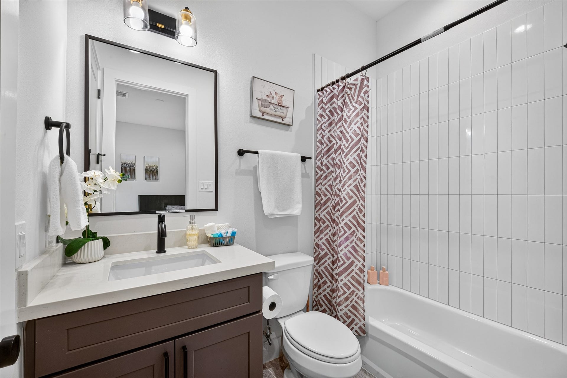 A vanity and shower-tub combination wrapped in tile give this private bath a fresh, contemporary finish consistent with the home's overall design.