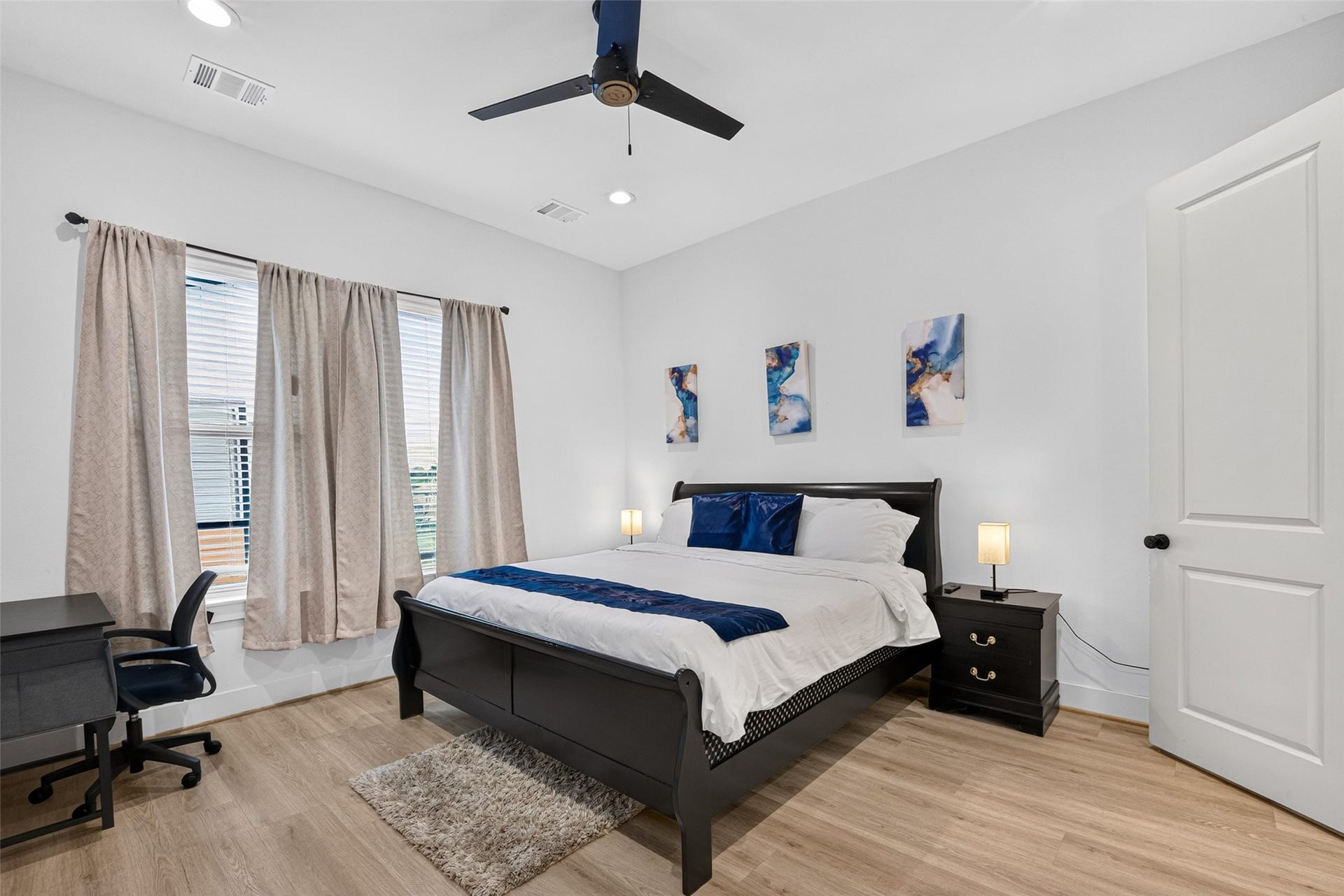 Generous proportions, large windows, and a ceiling fan give the primary bedroom a comfortable, airy feel, with direct access to the en-suite bath and a spacious full-entry closet.