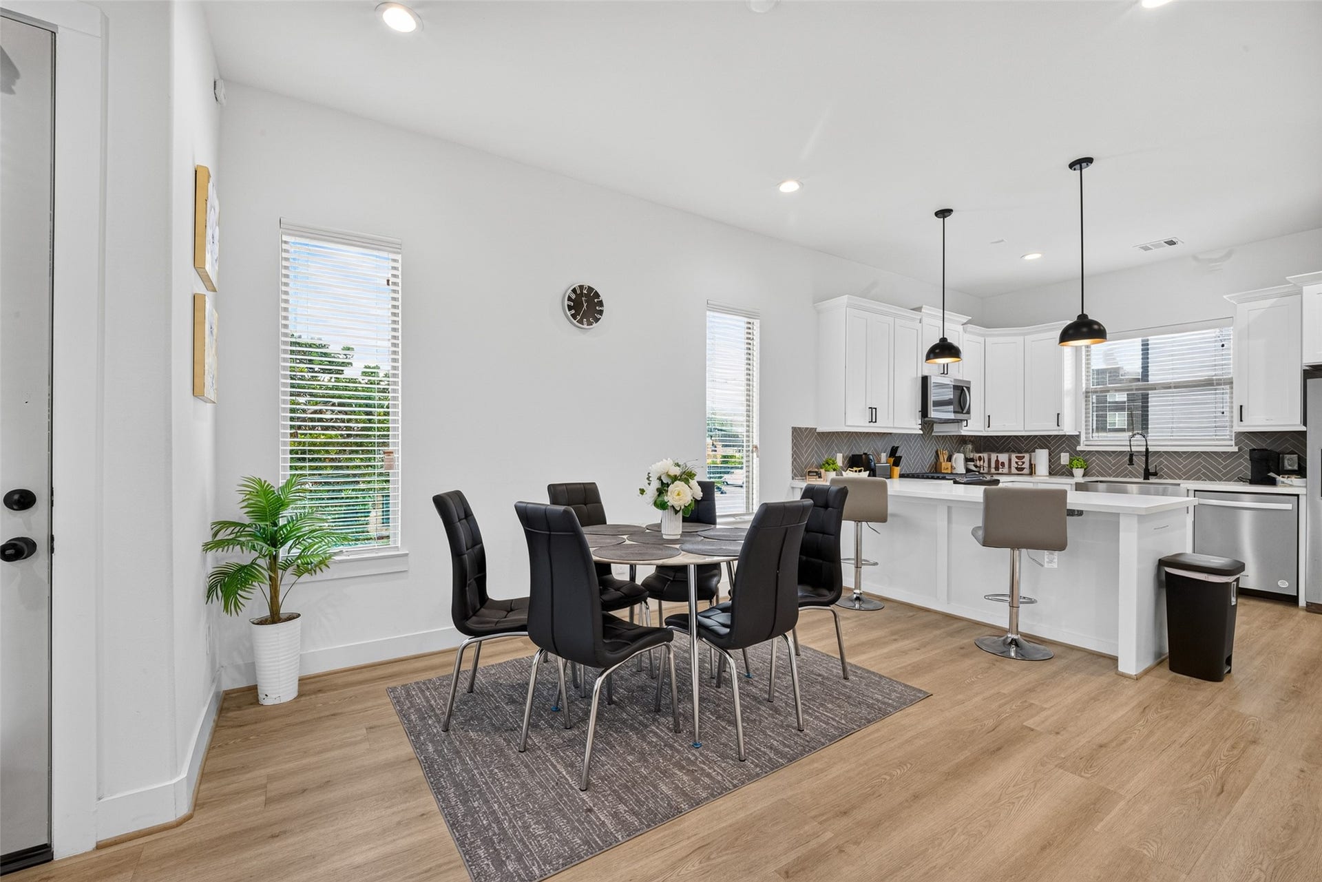Tall vertical windows frame the dedicated dining space, creating an airy, sunlit nook ideal for morning coffee and every meal.