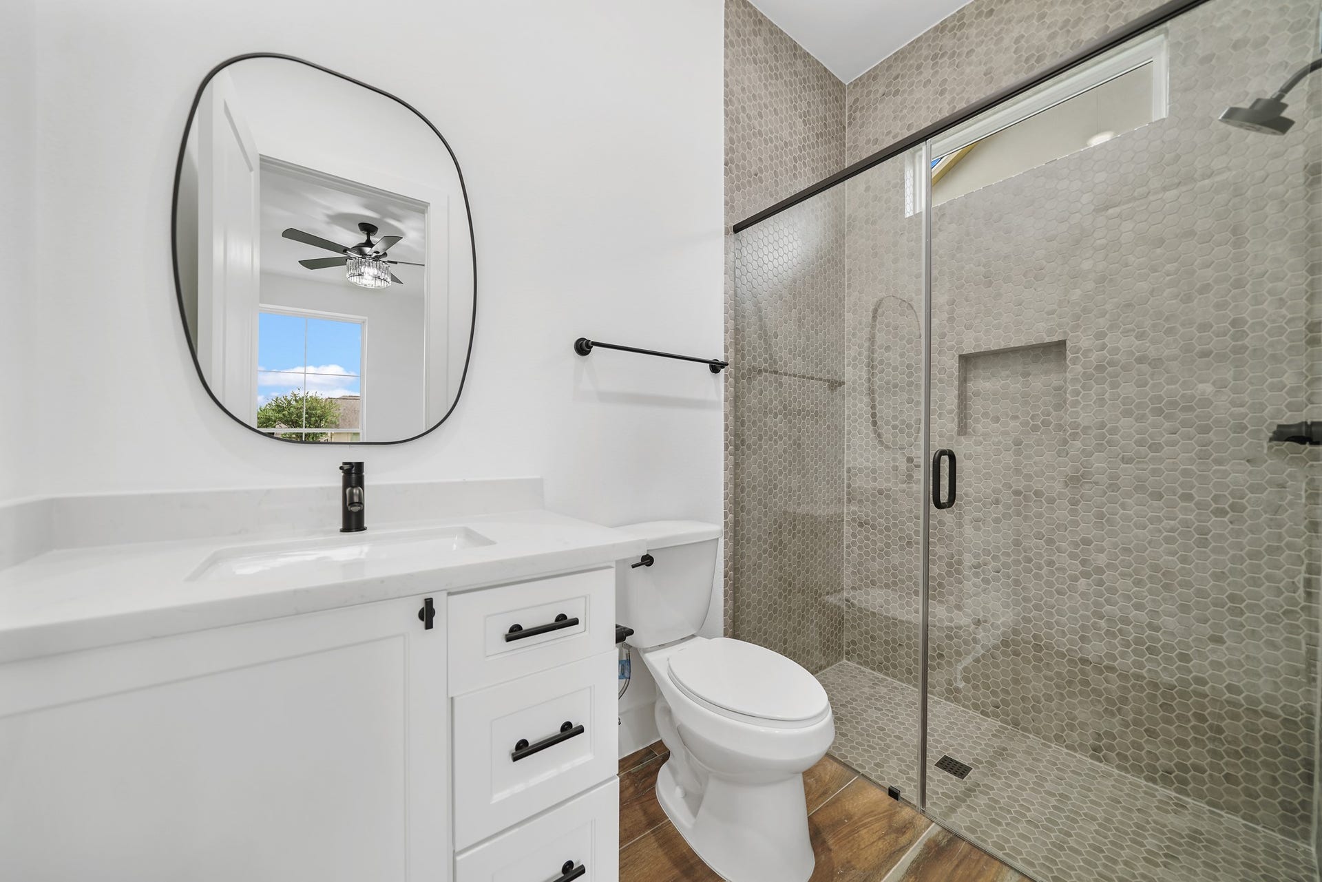 Indulge your guests in the luxurious comfort of the guest ensuite, featuring the same exquisite finishes found throughout the home's bathrooms. From the elegant quartz countertops to the designer tile and upgraded fixtures, no detail has been spared in creating a refined and welcoming space.