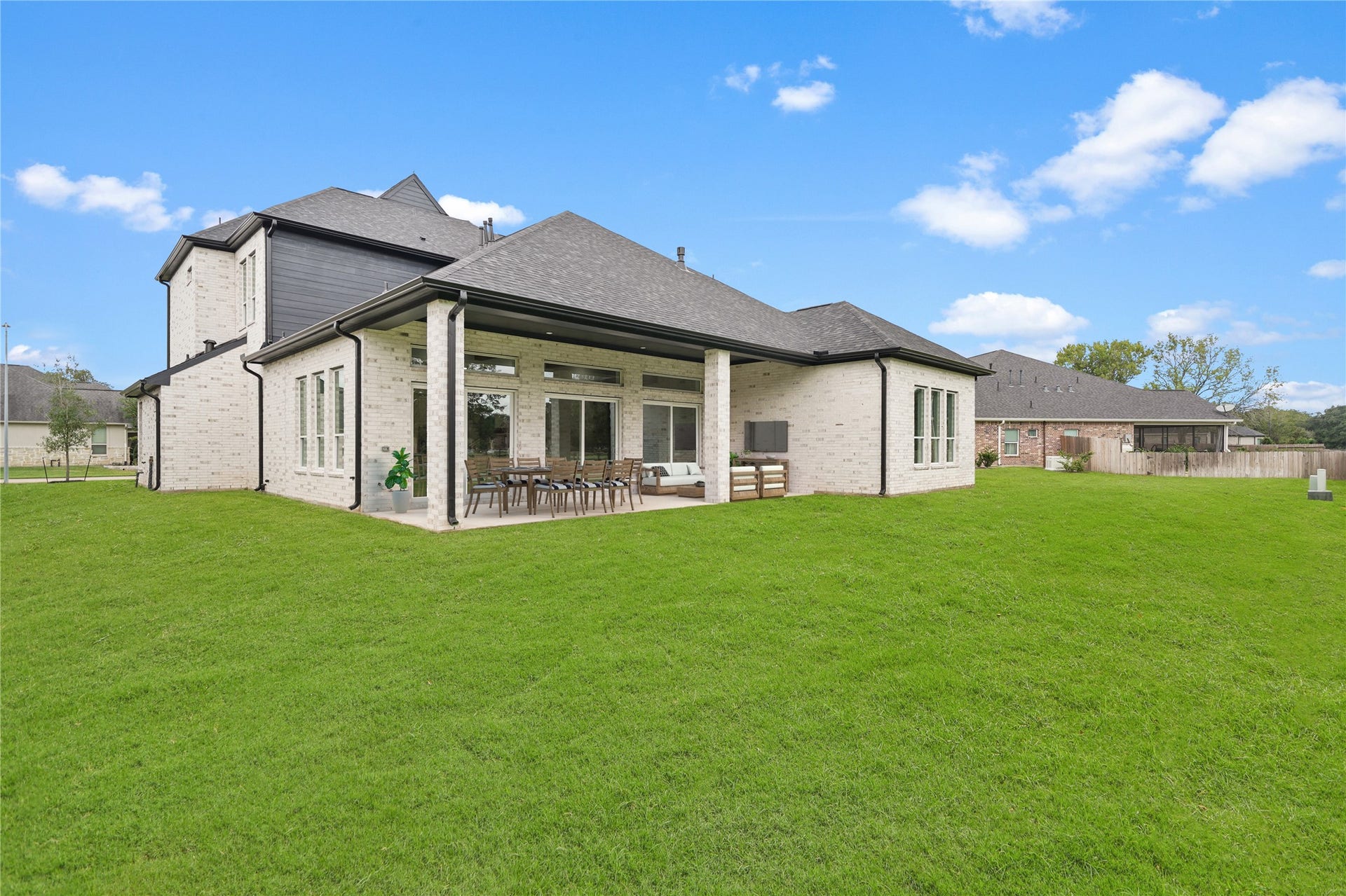 Perimeter fence has been installed. 
 Embrace the outdoors in the expansive back patio, featuring soaring high ceilings that ensure abundant natural light floods the space. Carefully designed to avoid compromising the brightness of the house, this outdoor retreat offers a seamless blend of comfort and openness. Whether entertaining guests or enjoying a quiet moment, the abundant patio invites you to savor the beauty of the outdoors without sacrificing the luminosity of the home's interior. Virtually staged