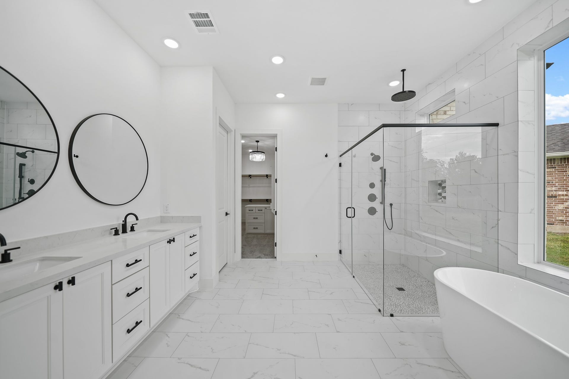 Step into indulgence in the owners' ensuite, where luxury knows no bounds. The focal point is a spacious two-person walk-in shower, complete with independent temperature valves, accompanied by a freestanding tub for the ultimate relaxation. Upgraded fixtures, quartz countertops, designer tile, and strategically placed LED lighting elevate the aesthetics, ensuring every detail reflects a commitment to exquisite craftsmanship and refined taste.