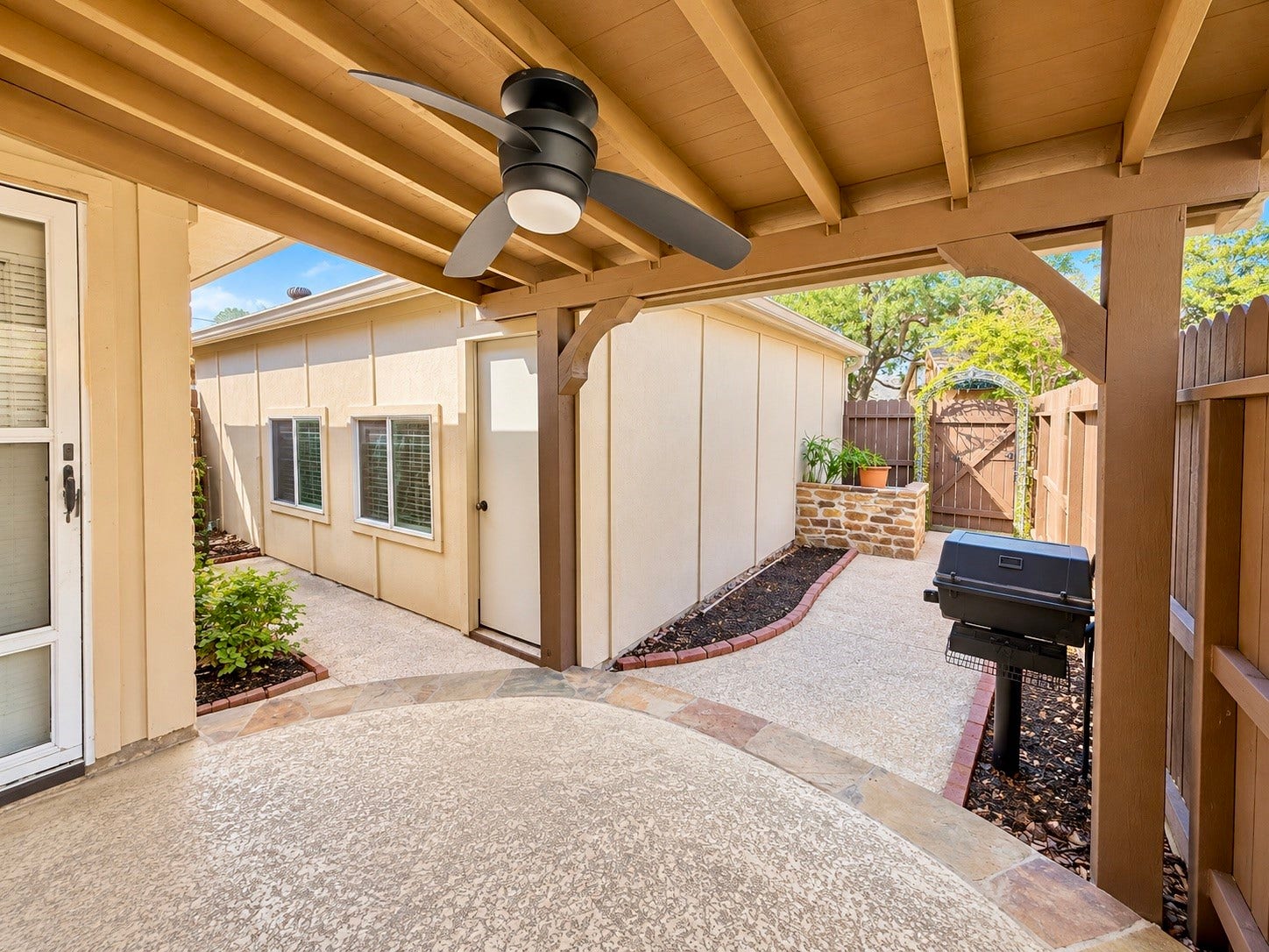View of the super useful fully fenced in backyard with a great sized 2 car detached garage.