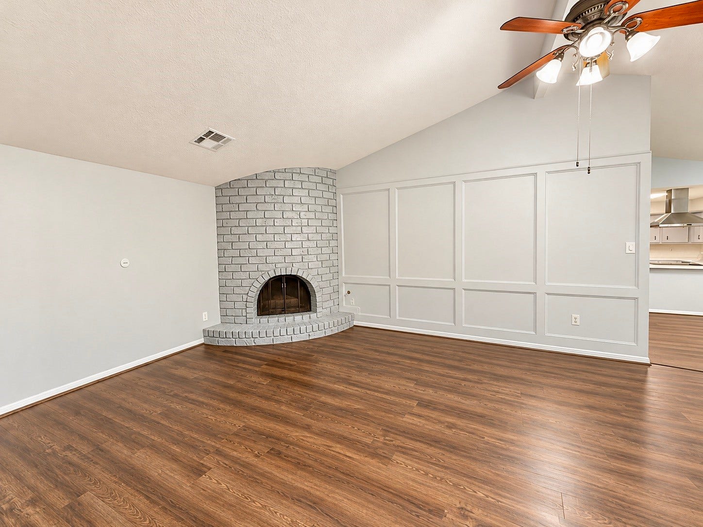 Living Room features a handsome corner fireplace, and detailed wall trim decor.