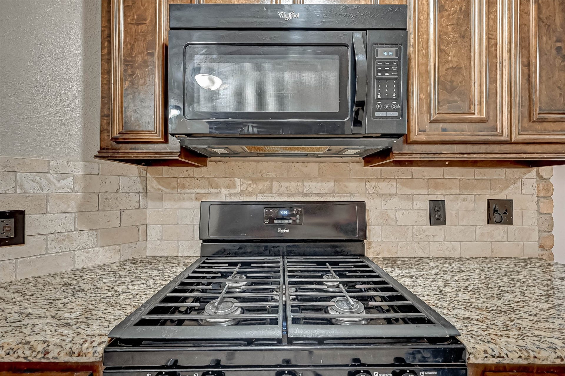 3510 Greenwood Dr Drive, Sugar Land, TX 77478 A microwave is conveniently located above a freestadning gas stove.