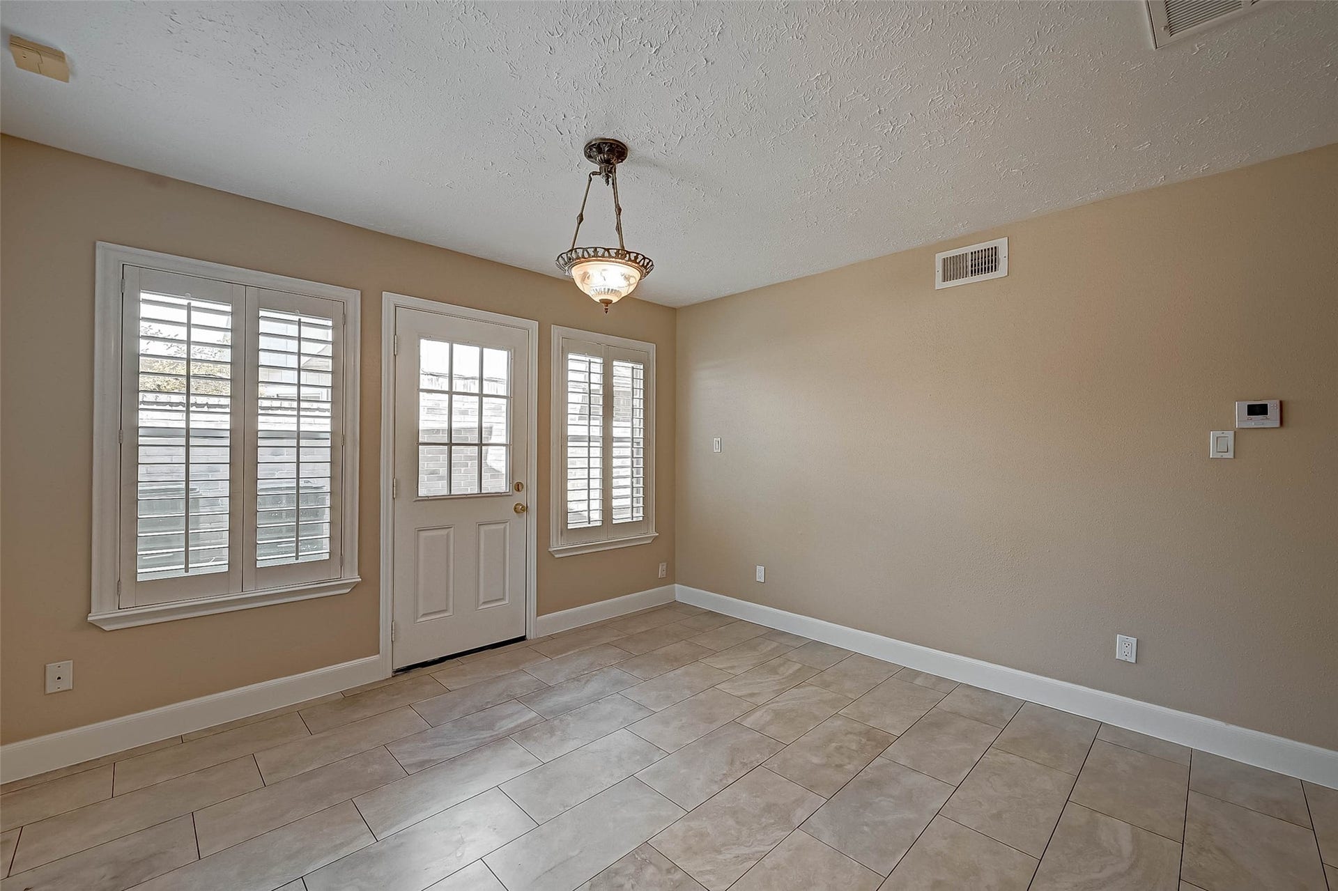 3510 Greenwood Dr Drive, Sugar Land, TX 77478 The door goes out to the side yard. Look at that amazing light fixture!