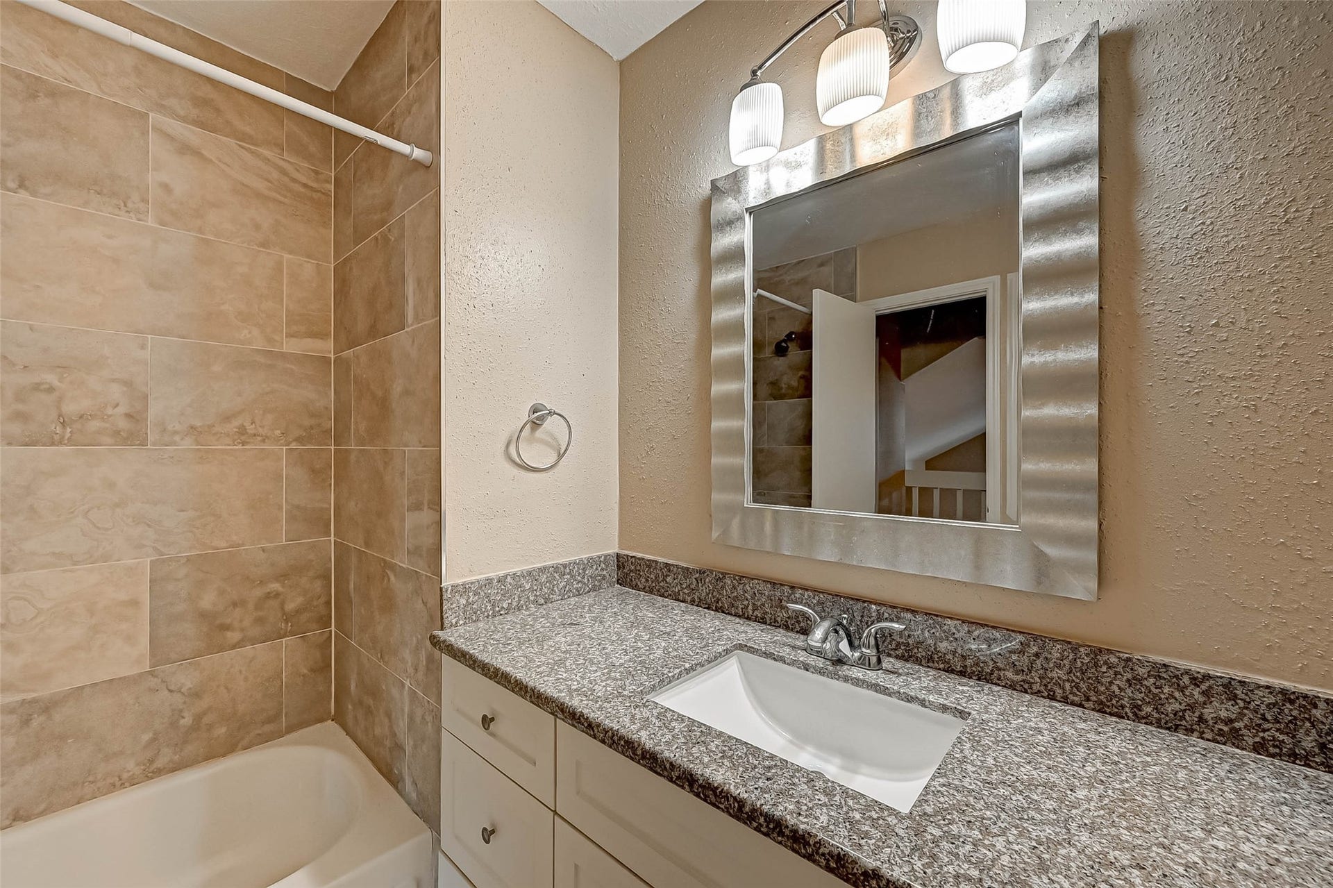 3510 Greenwood Dr Drive, Sugar Land, TX 77478 Modern mirrors add pizzazz in this renovated upstairs bathroom!