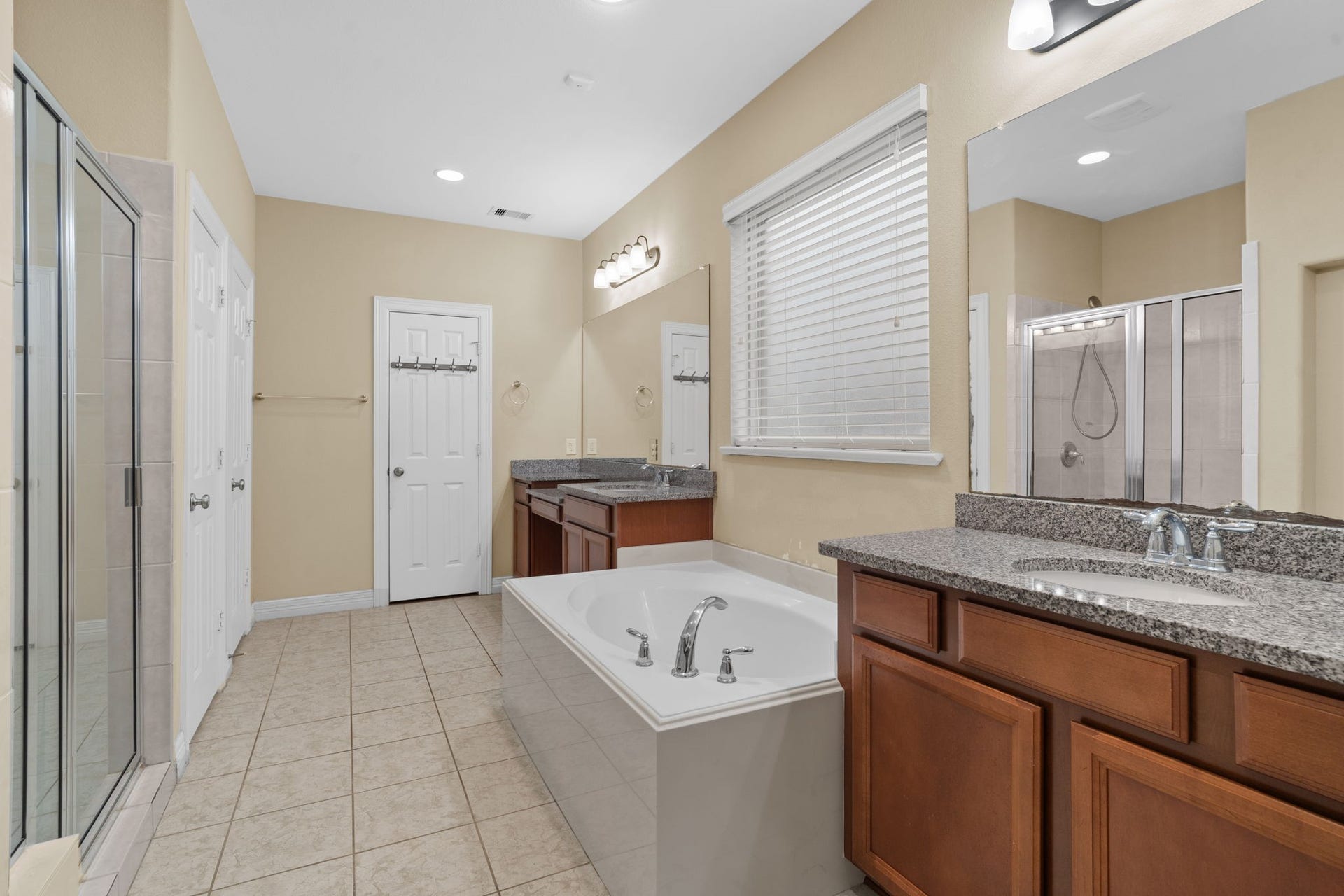 5515 Mangrove Creek Lane, Sugar Land, TX 77479 Relax in the soaking tub or enjoy a refreshing rinse in the separate walk-in shower. Designed for two, the spacious primary bath also features dual vanities, a linen closet, a private water closet, and an expansive walk-in closet.