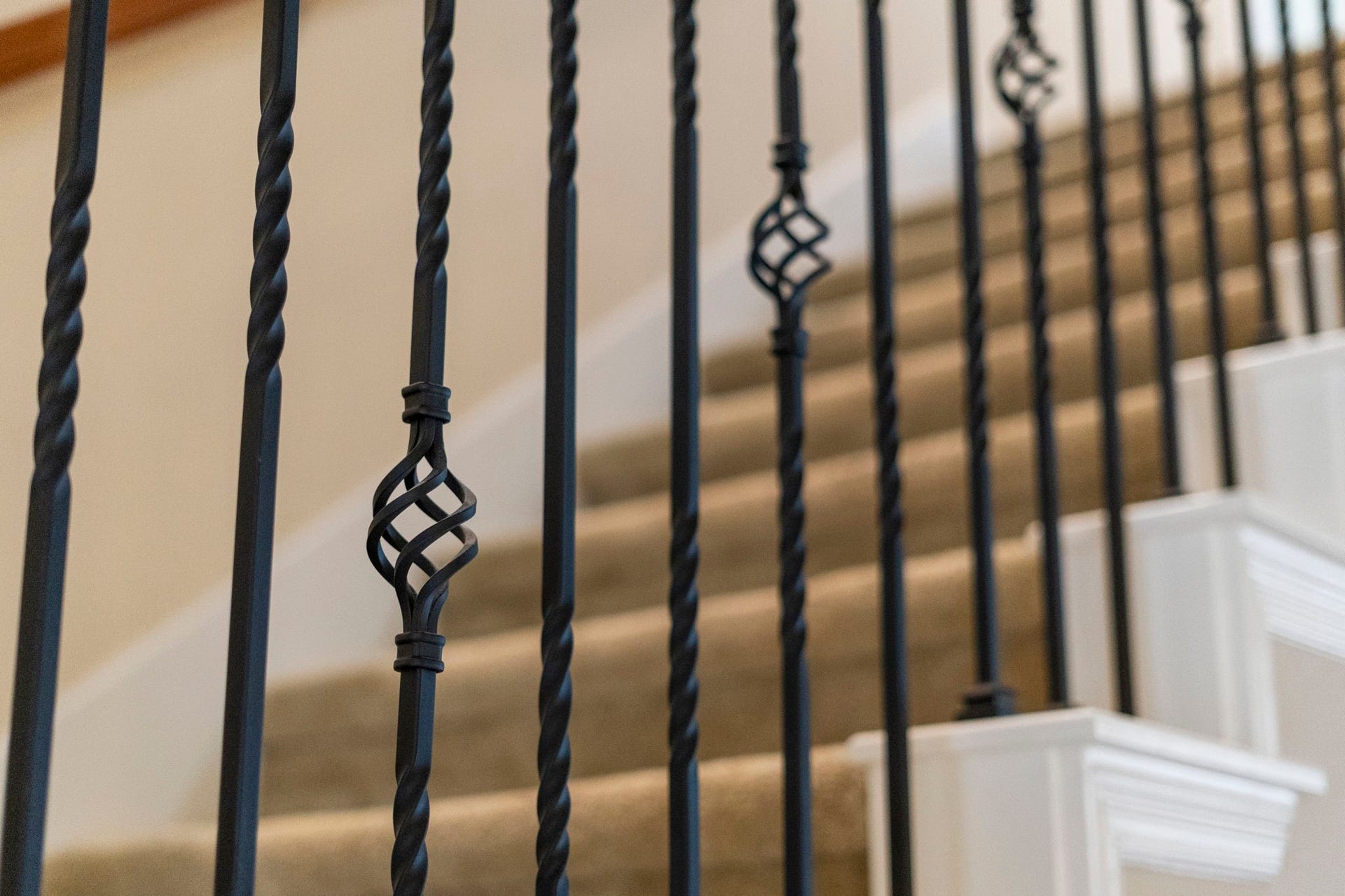 5515 Mangrove Creek Lane, Sugar Land, TX 77479 Classic staircase accented by wrought-iron balusters and rich wood details.