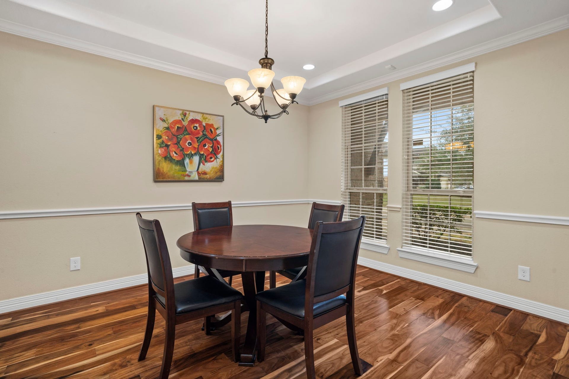 5515 Mangrove Creek Lane, Sugar Land, TX 77479 The well-appointed dining room features a tray ceiling with recessed lighting, elegant chair rail and crown molding, and large windows that fill the space with natural light.