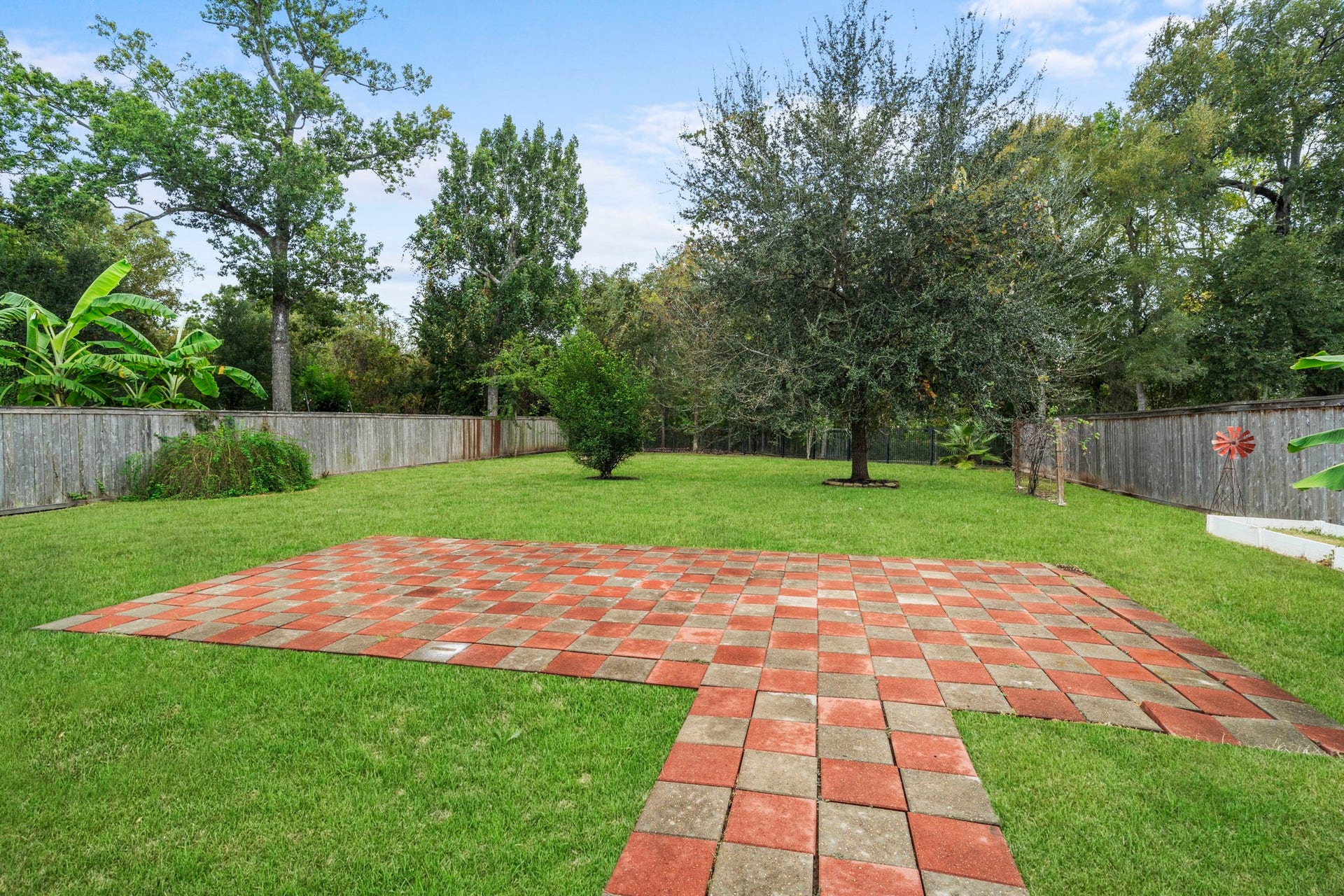 5515 Mangrove Creek Lane, Sugar Land, TX 77479 Fully fenced backyard with paved areas offering space to create inviting outdoor living and entertaining areas.