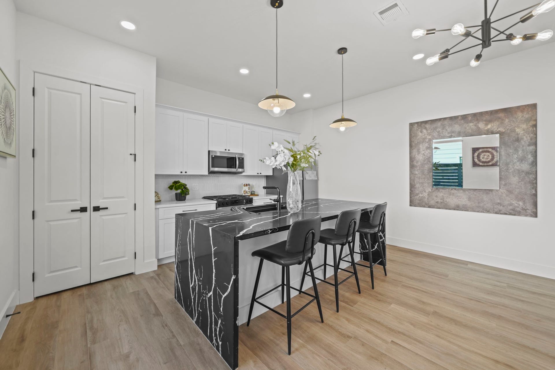 The kitchen centers on the elegant island and breakfast bar with a full size pantry.