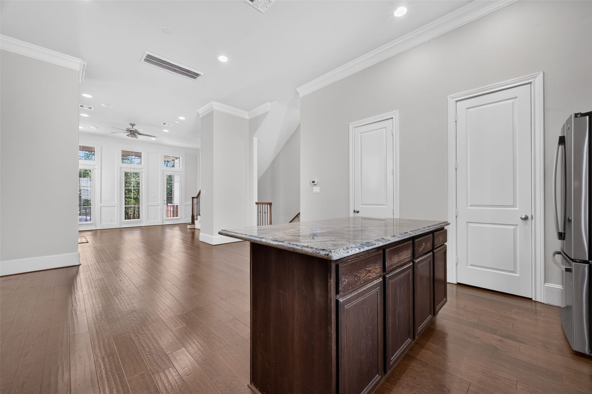 6610 Toledo Street, Houston, TX 77008 Bright and spacious open-concept living area with elegant hardwood floors, a modern kitchen island, and large windows for abundant natural light.